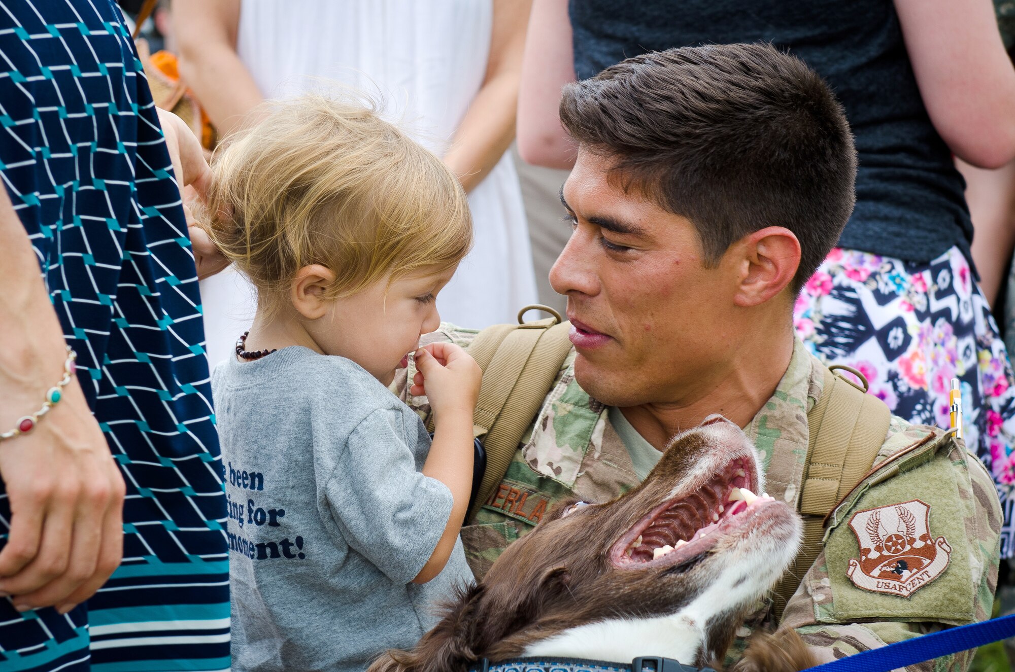 Capt. Trevor Sutherland, a pilot in the 165th Airlift Squadron, embraces his family during a homecoming ceremony at the Kentucky Air National Guard Base in Louisville, Ky., July 8, 2015. Sutherland and 29 other Kentucky Air Guardsmen returned from a deployment to the Persian Gulf Region, where they’ve been supporting Operation Freedom’s Sentinel since February. (U.S. Air National Guard photo by Master Sgt. Phil Speck)