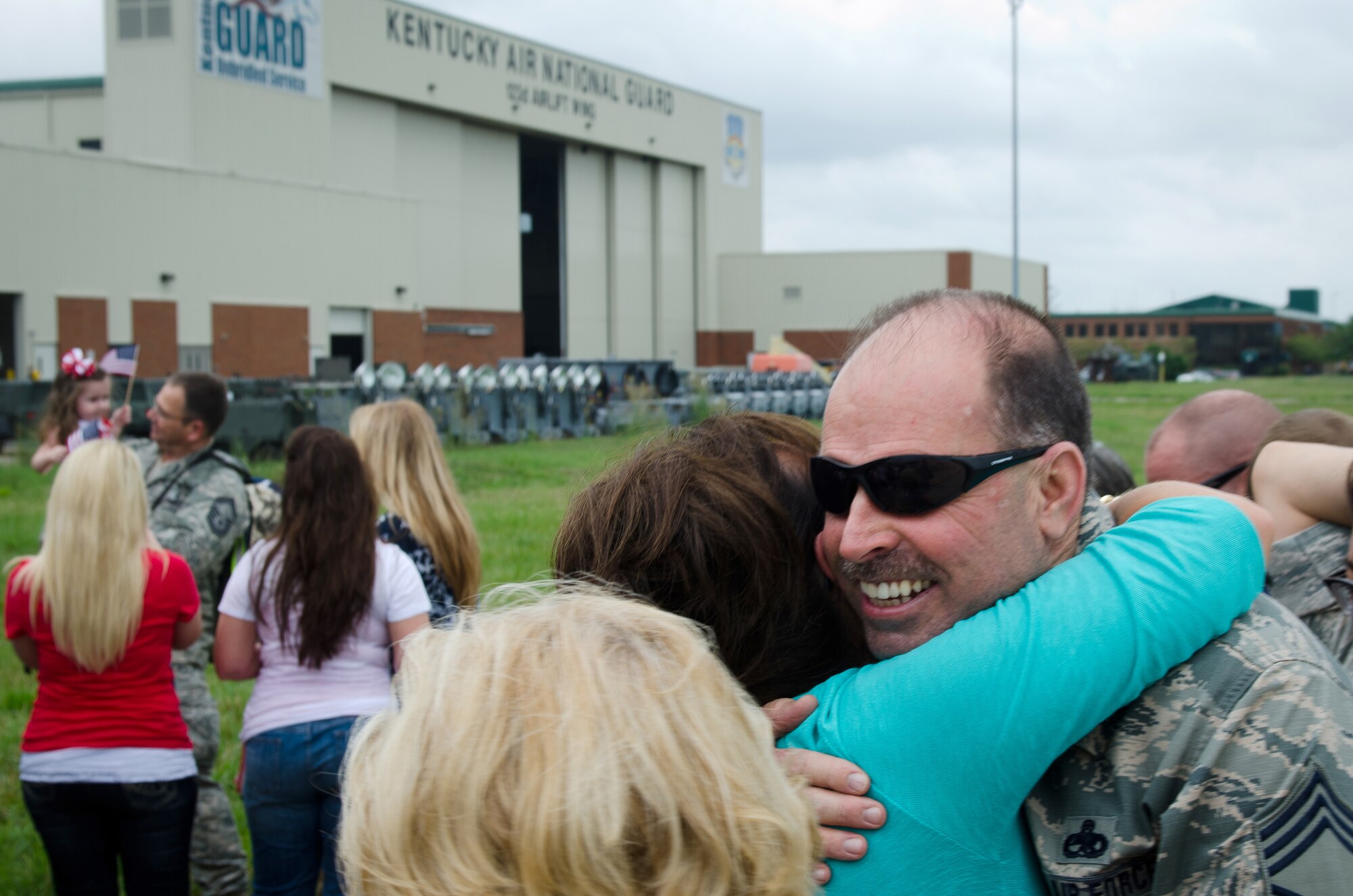 Chief Master Sergeant Steven Snawder, superintendent for the 123rd Aircraft Maintenance Squadron, hugs loved ones during a homecoming ceremony at the Kentucky Air National Guard Base in Louisville, Ky., July 8, 2015. Thirty Kentucky Air Guardsmen returned from a deployment to the Persian Gulf Region, where they’ve been supporting Operation Freedom’s Sentinel since February. (U.S. Air National Guard photo by Master Sgt. Phil Speck)