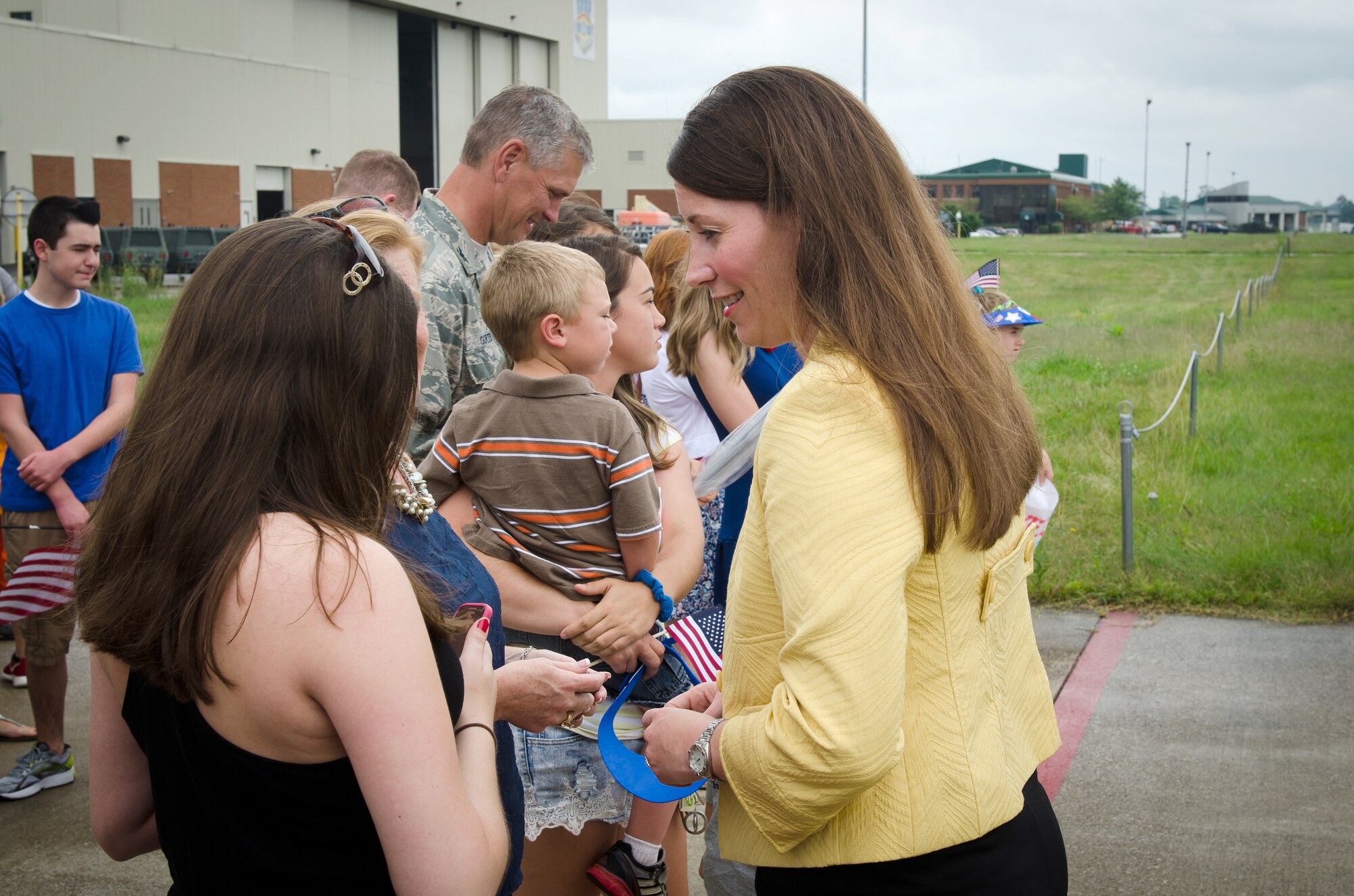 Alison Lundergan Grimes, Kentucky's secretary of state, talks to family members of Airmen from the 123rd Airlift Wing Airmen during a homecoming ceremony at the Kentucky Air National Guard Base in Louisville, Ky., July 8, 2015. Thirty Kentucky Air Guardsmen returned from a deployment to the Persian Gulf Region, where they’ve been supporting Operation Freedom’s Sentinel since February. (U.S. Air National Guard photo by Master Sgt. Phil Speck)
