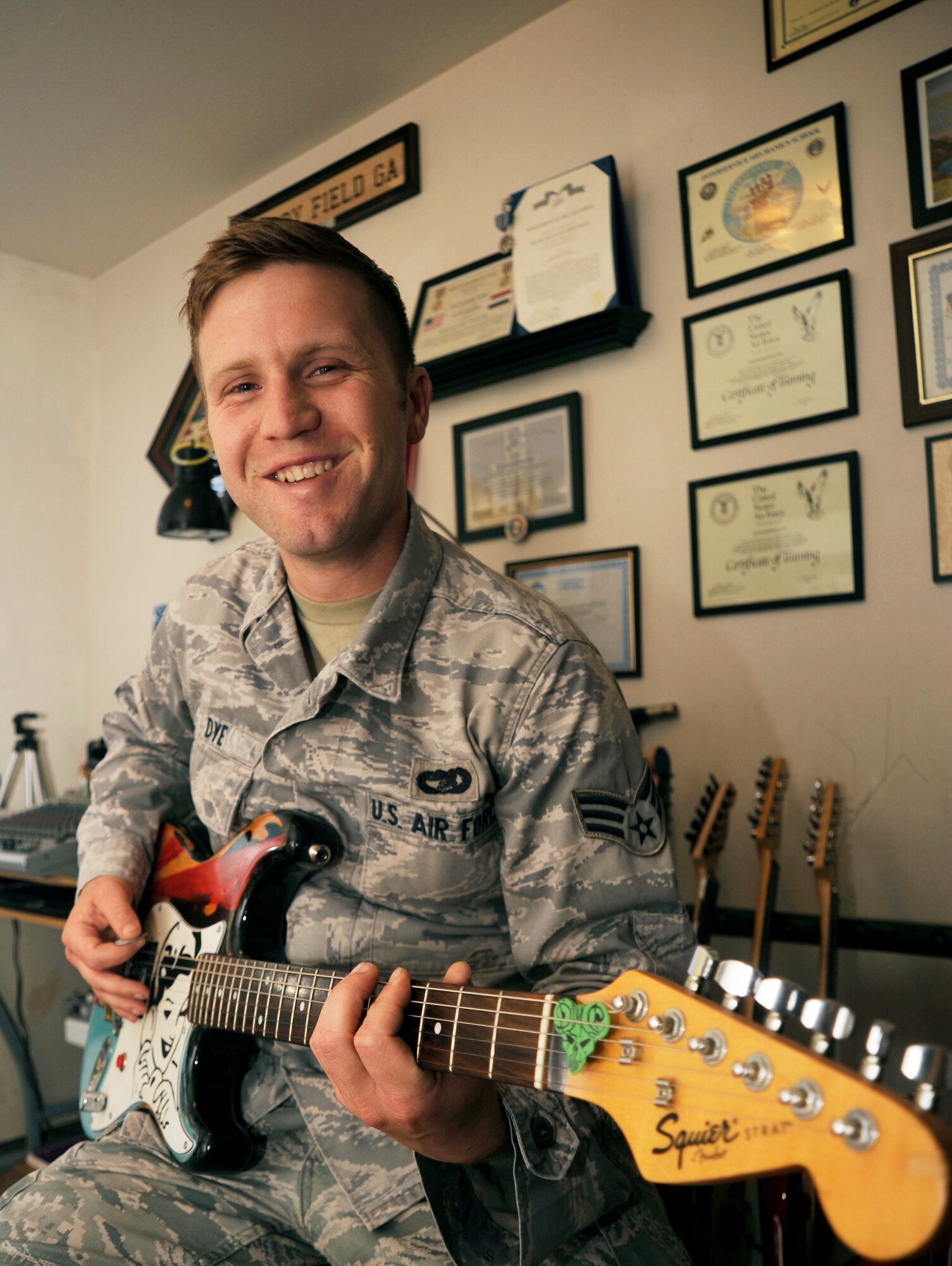Senior Airman Richard Dye, 30th Logistics Readiness Squadron vehicle maintenance journeyman, practices guitar in his home recording studio, July 8, 2015, Vandenberg Air Force Base, Calif.  While not the most grandiose of studios, it is enough for Dye to create punk-inspired ballads and share them with the world via social media. (U.S. Air Force photo by Airman 1st Class Ian Dudley/Released)