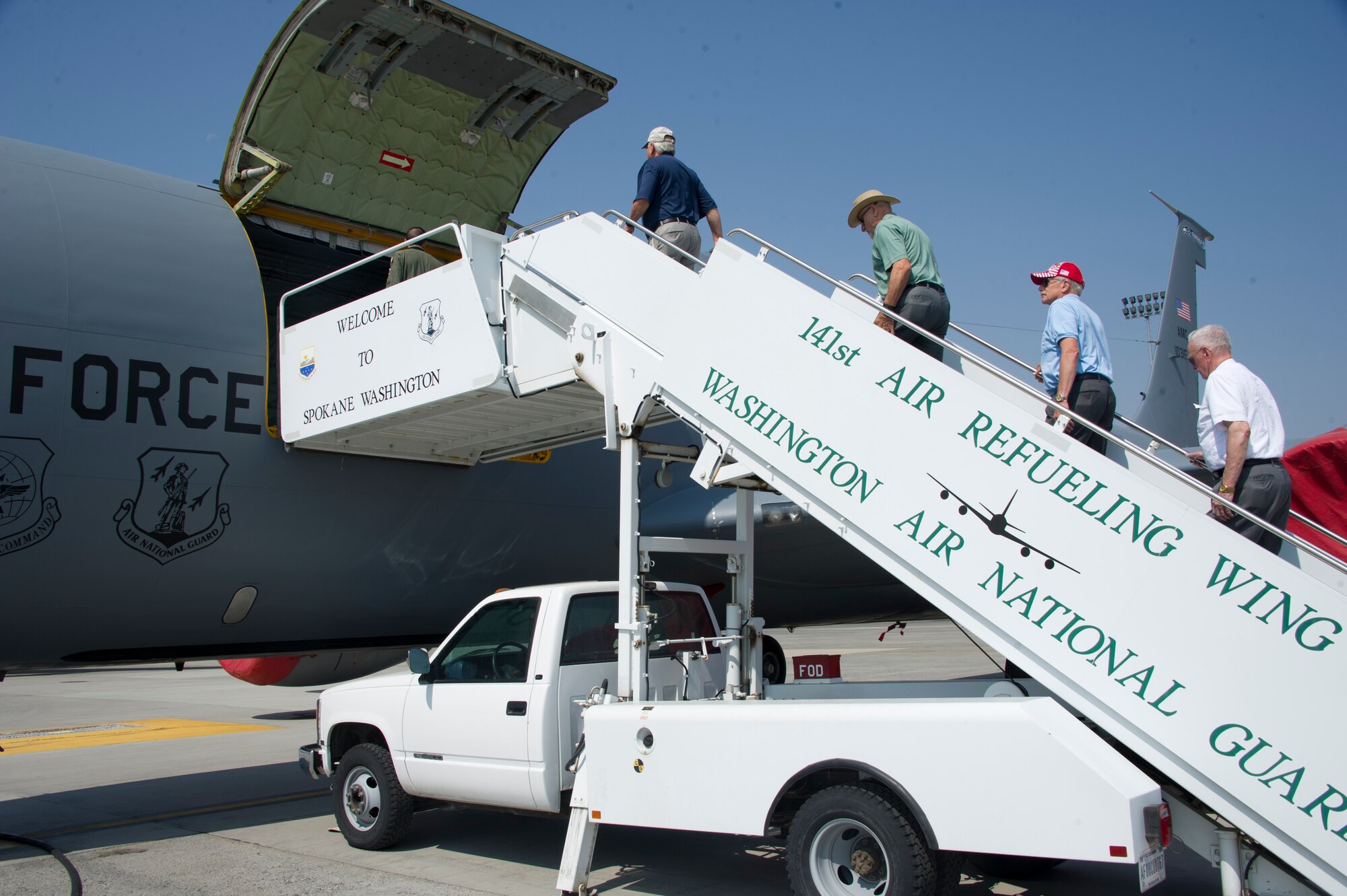 Members from the Masonic Lodges of Washington ascend the air stairs onto a KC-135 Stratotanker, July 8, 2015, at Fairchild Air Force Base, Wash. The members of the Masonic Lodges of Washington received a tour of the aircraft after bestowing an award to 1st Lt. Meagan Wyngarden, 93rd Air Refueling Squadron KC-135 Stratotanker pilot, for her contributions to the community. (U.S. Air Force photo/Airman 1st Class Nicolo J. Daniello)