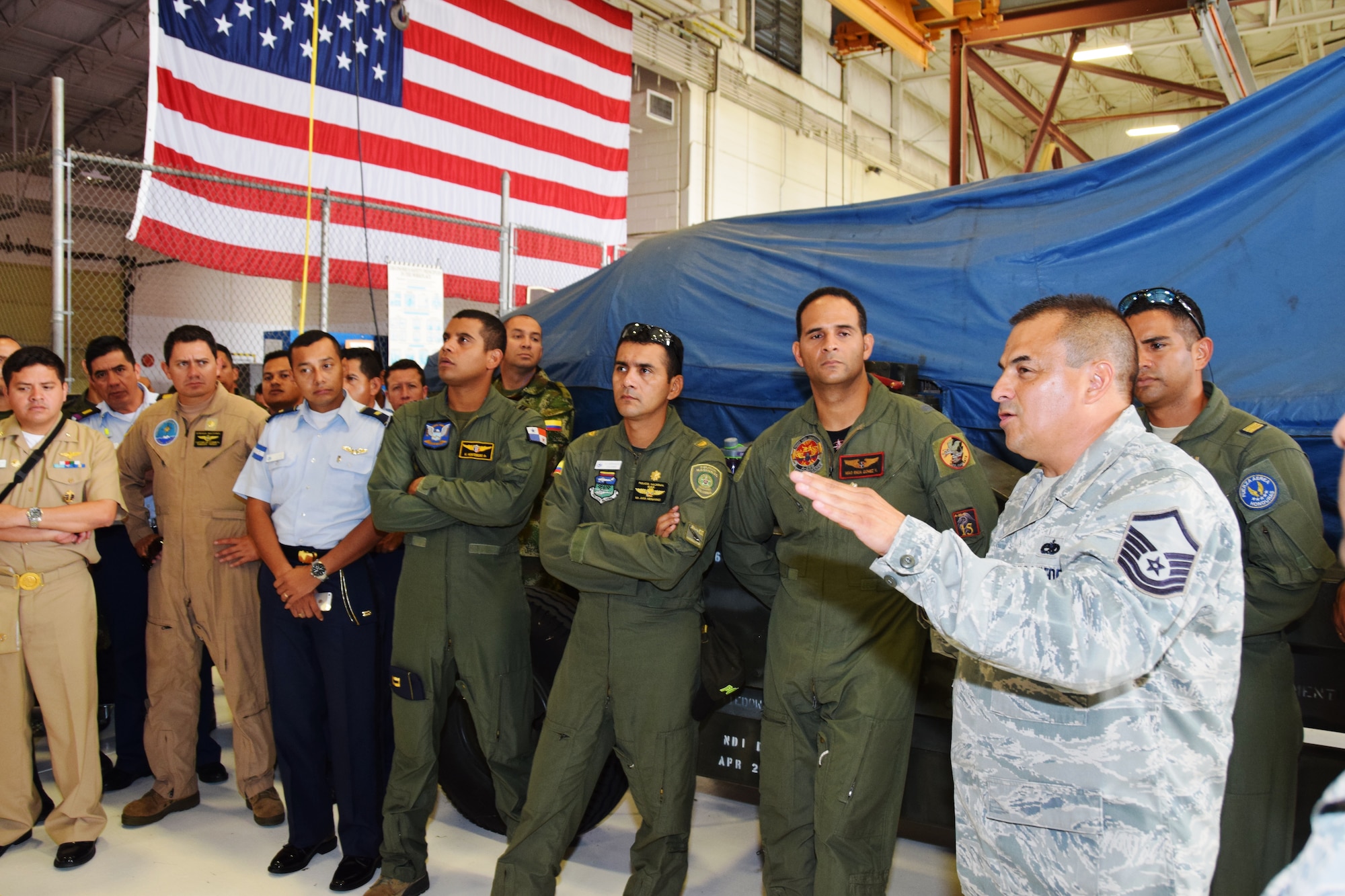 Master Sgt. Carlos Medrano Jr. (right), aircraft engine supervisor with the 433rd Maintenance Squadron, Joint Base San Antonio-Lackland, Texas talks about  engine maintenance and repairs on the C-5A Galaxy to students from Inter-American Air Forces Academy at Joint Base San Antonio-Lackland, Texas on July 8, 2015. (U.S. Air Force photo/Tech Sgt. Carlos J. Trevino)