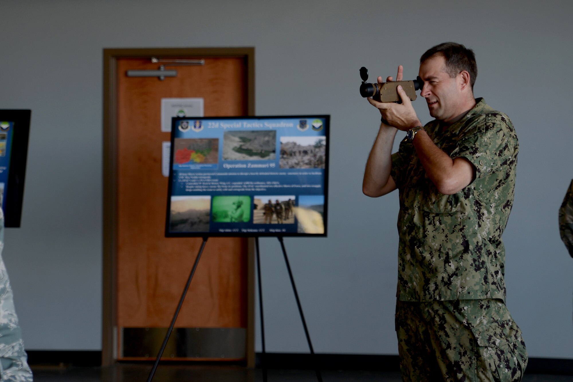 Fleet Master Chief Petty Officer Mark Rudes, U.S. Pacific Command fleet command master chief, looks through a spot on target thermal imager at the 22nd Special Tactics Squadron June 7, 2015, at Joint Base Lewis-McChord, Wash. The 22nd STS trains, equips, and employs combat control, tactical air control party and combat mission support Airmen. (U.S. Air Force photo/Airman 1st Class Keoni Chavarria)