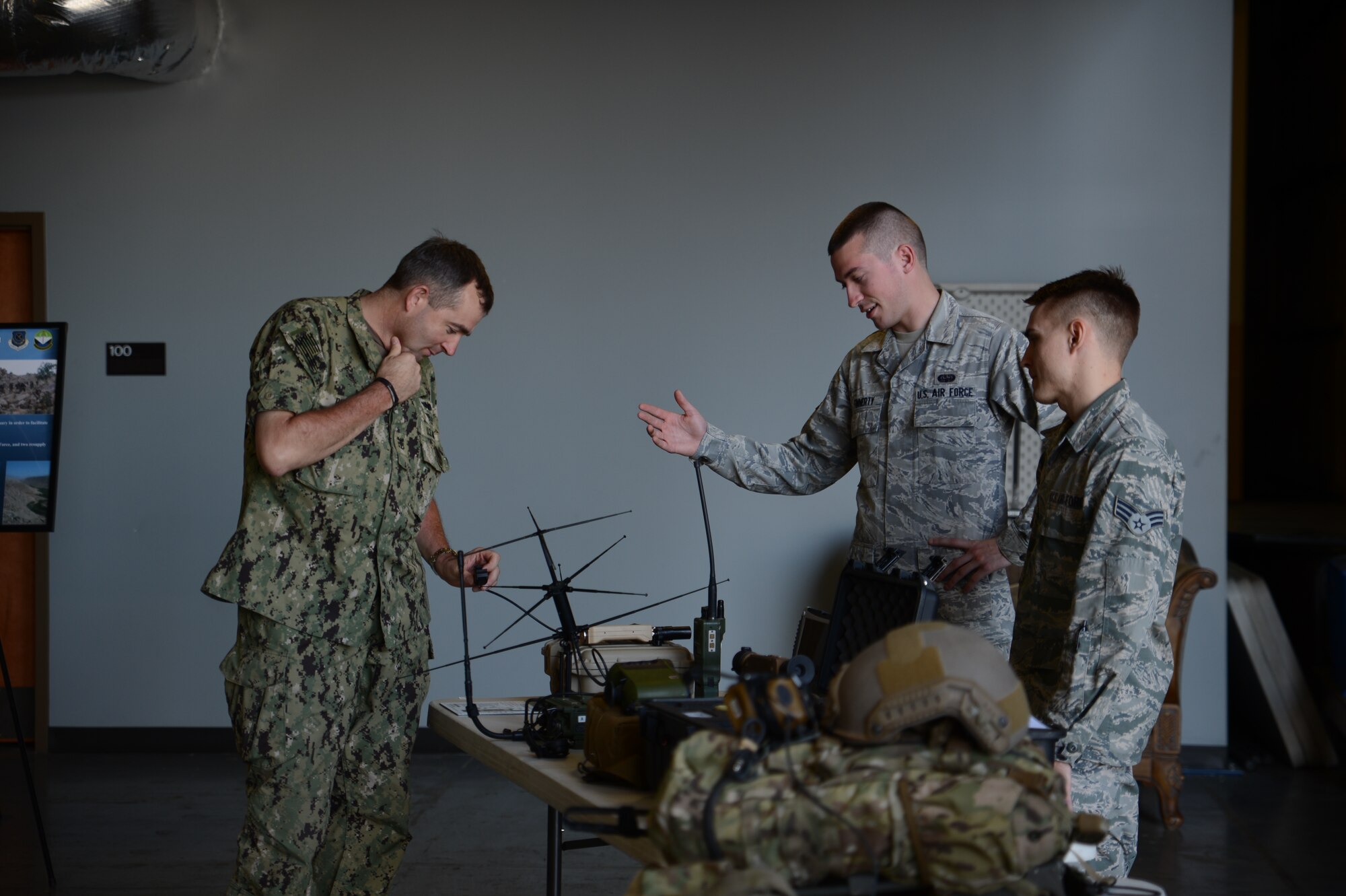 Fleet Master Chief Petty Officer Mark Rudes (left), U.S. Pacific Command fleet command master chief, listens to Senior Airman Jacob Finnerty, 22nd Special Tactics Squadron radio maintenance technician, while looking at equipment from the 22nd STS July 7, 2015, at Joint Base Lewis-McChord, Wash. Rudes assumed the duties as the senior enlisted advisor to U.S. Pacific Command in April 2012. (U.S. Air Force photo/Airman 1st Class Keoni Chavarria)