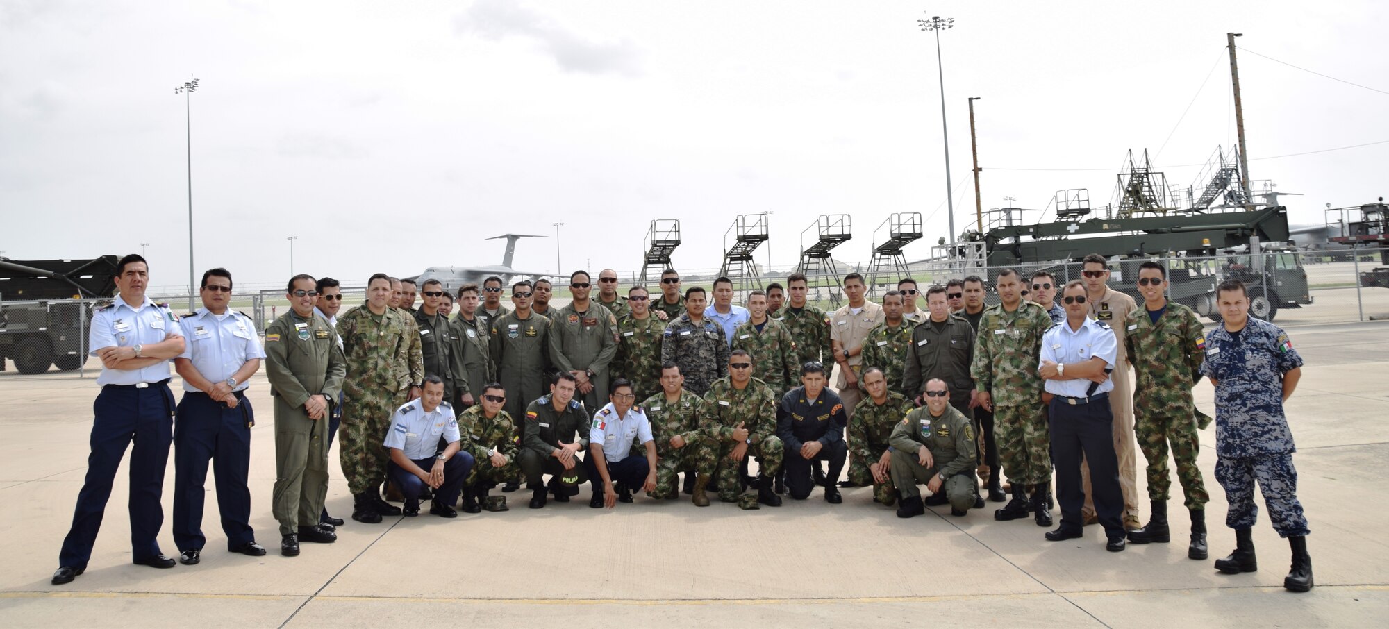 More than 40 students from the Inter-American Air Forces Academy, located at Joint Base San Antonio-Lackland, Texas, pose for a group photo after a tour of the C-5A Galaxy and maintenance shops at the 433rd Airlift Wing,  July 8, 2015. Since 1993, IAAFA students have visited the "Alamo Wing" maintenance shops as part of their aircraft maintenance and logistics studies. (U.S. Air Force photo/Tech Sgt. Carlos J. Trevino))