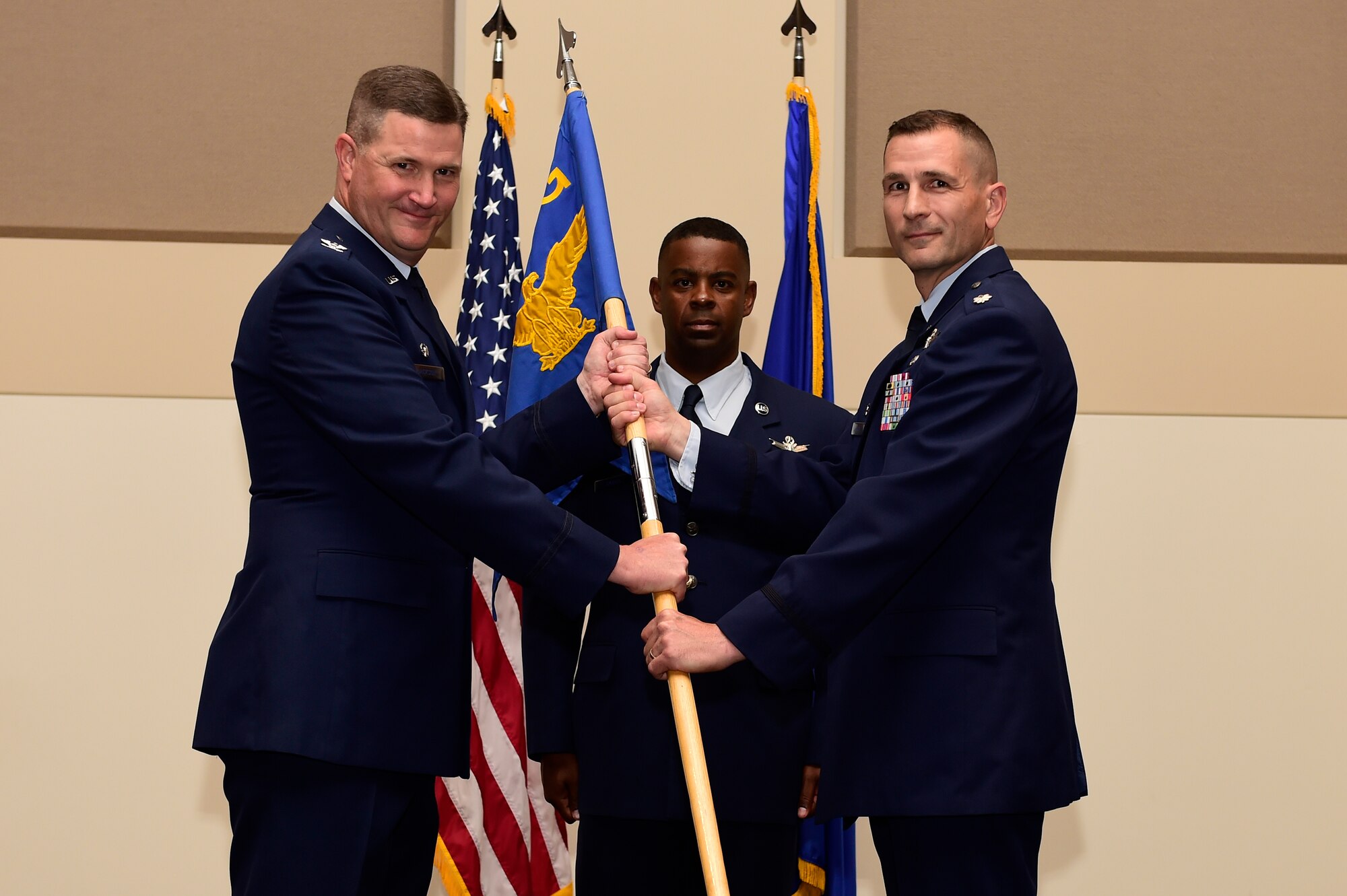 Lt. Col. Francois Roy, right; relinquishes his command of the 2nd Space Warning Squadron to Col. Michael Jackson, 460th Operations Group commander, left; during the change of command ceremony July 7, 2015, on Buckley Air Force Base, Colo. Roy led the squadron since July 2013. (U.S. Air Force photo by Staff Sgt. Stephany Richards/Released)