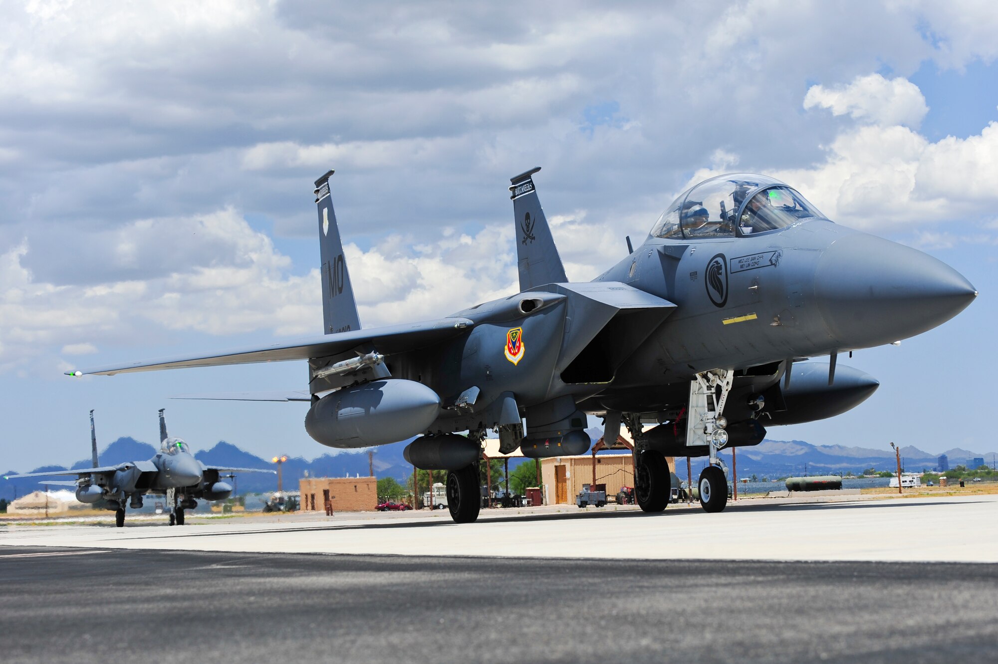 F-15SG fighter jets from the 428th Fighter Squadron at Mountain Home Air Force Base, Idaho, taxi from the runway at Davis-Monthan Air Force Base, Ariz., July 7, 2015. Ten of the fighters arrived to train at D-M until Aug. 24 while MHAFB's runway is closed for maintenance. (U.S. Air Force photo by Airman 1st Class Chris Drzazgowski/Released)
