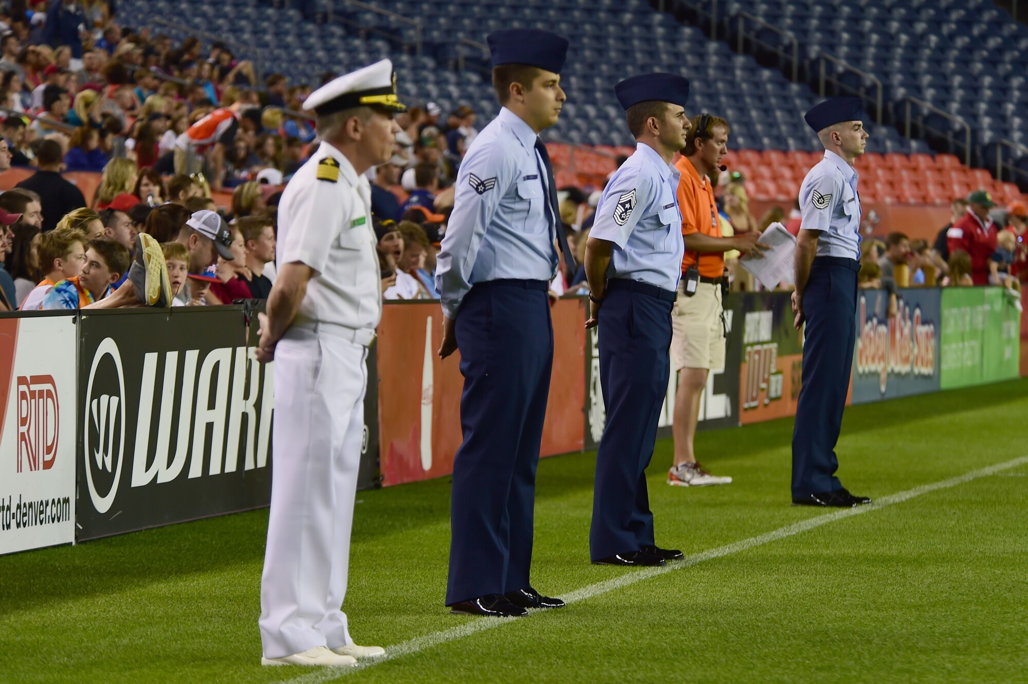 Military members line up to be honored after the Major League Lacrosse game between the Denver Outlaws and the Boston Cannons July 4, 2015, at Sports Authority Field at Mile High Stadium in Denver. The Outlaws honored military members with a standing ovation and video tribute at the end of the game. (U.S. Air Force photo by Airman 1st Class Luke W. Nowakowski/Released)