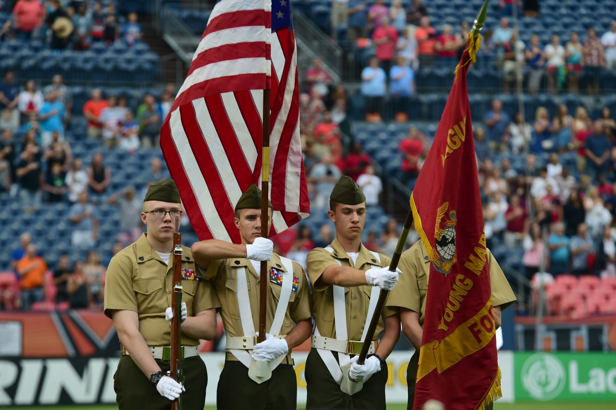 Reserve Officer Training Corps members bear the flag during the National Anthem July 4, 2015, at Sports Authority Field at Mile High Stadium in Denver.  The Denver Outlaws hosted the Boston Cannons in a Major League Lacrosse game which honored military members on Independence Day. (U.S. Air Force photo by Airman 1st Class Luke W. Nowakowski/Released) 