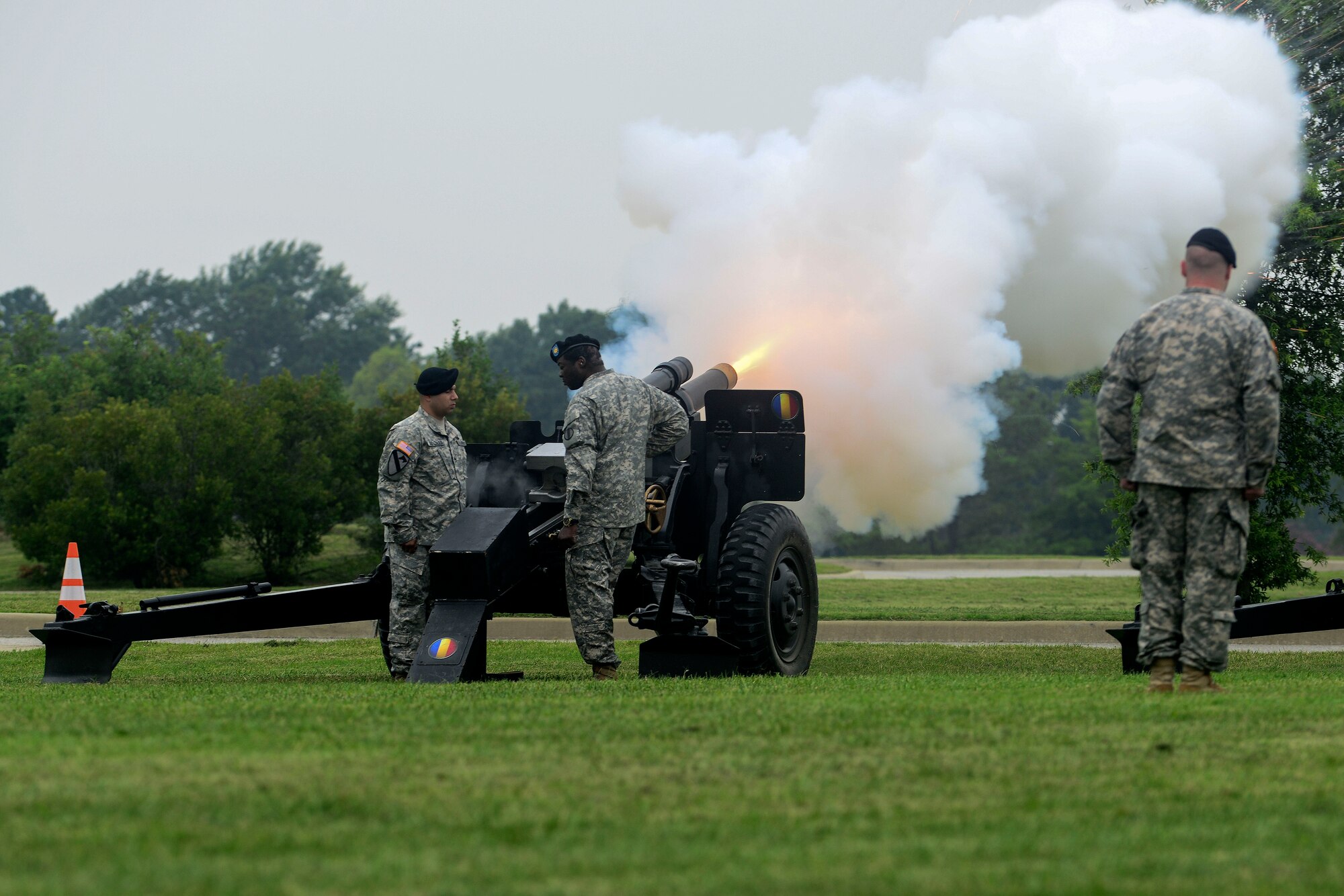 U.S. Army Soldiers assigned to the U.S. Army Training and Doctrine Command Salute Battery fire cannons in honor of the Center for Initial Military Training change of command and retirement ceremony at Fort Eustis, Va., July 2, 2015. At the conclusion of the ceremony honoring retirement and releasing of command of Maj. Gen. Ross Ridge, Center for Initial Military Training former commander, a shell casing from the final blast was presented as a memento of his service. (U.S. Air Force photo by Senior Airman Kimberly Nagle/Released)
