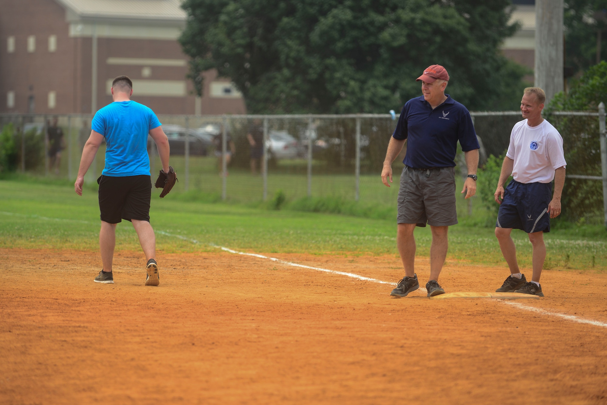 U.S. Air Force Col. John Allen, 633rd Air Base Wing commander, and Chief Master Sgt. Mark Hurst, 633rd ABW command chief master sergeant, compete in a softball game during a Warrior Day at Langley Air Force Base, Va., July 2, 2015. Allen and Hurst played on the winning “eagles and chiefs” team during the softball tournament.(U.S. Air Force photo by Senior Airman Kimberly Nagle/Released)
