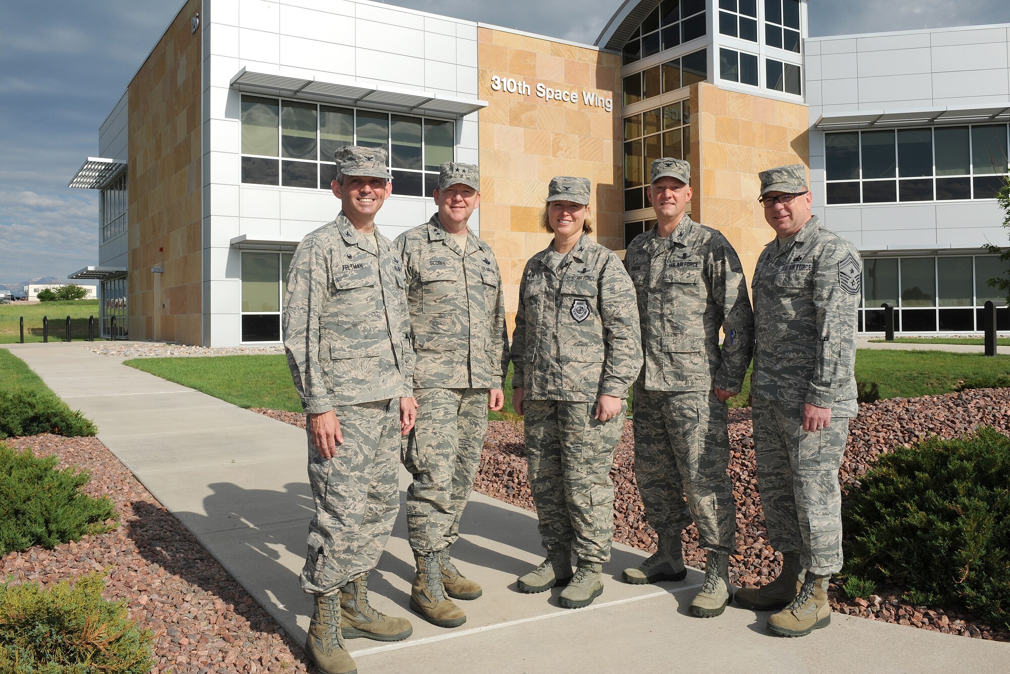 Maj. Gen. Richard Scobee, 10th Air Force commander, poses with 310th and 50th Space Wing leaders during a visit to Schriever Air Force Base on June 29.  From left to right are Col. Damon Feltman, 310th SW commander, General Scobee, Col. Deanna Burt, 50th SW commander, Col. Robert Claude, 310th SW vice-commander, and Chief Master Sgt. Gary Brown, 310th SW command chief.  Scobee toured 310th SW units, observed satellite operations, and was given an update on the upcoming mission support group move during his visit.  (U.S. Air Force Photo/Dennis Rogers)