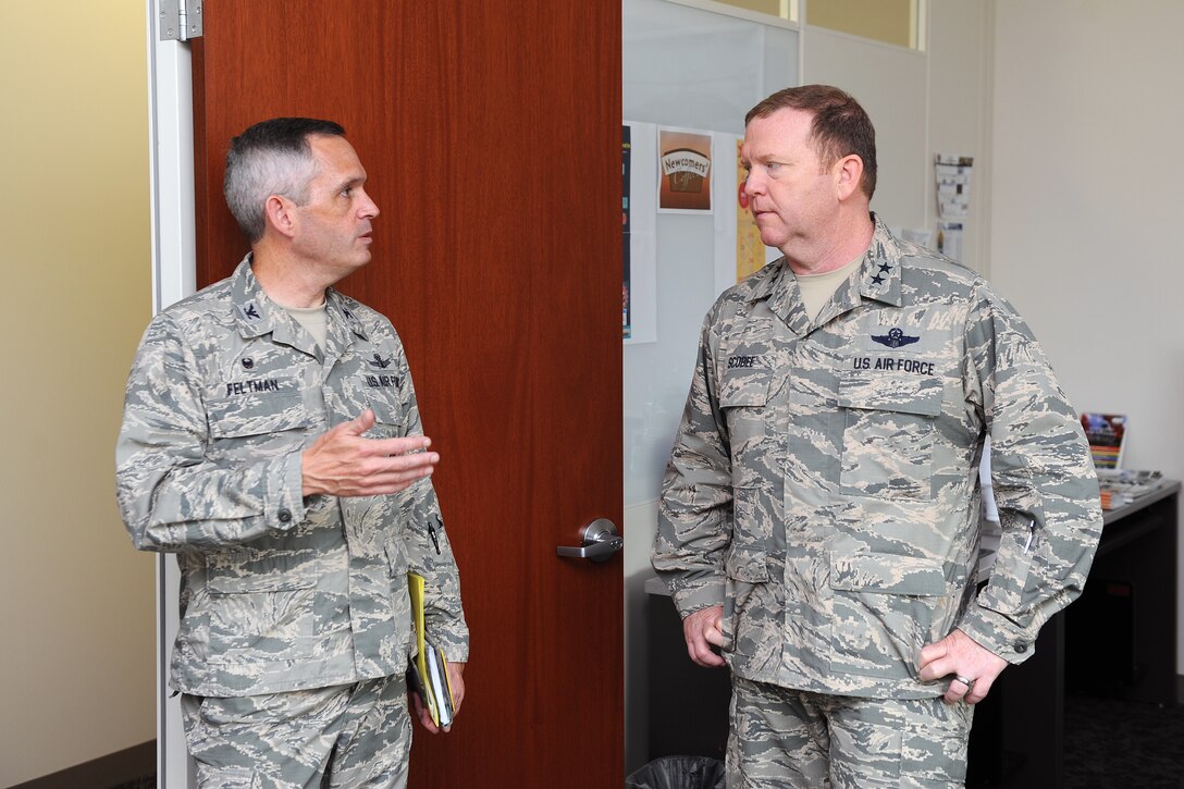 Maj. Gen. Richard Scobee, 10th Air Force commander, and Col. Damon Feltman, 310th Space Wing commander, tour the wing headquarters building during Scobee’s visit to Schriever Air Force Base on June 29.  Scobee toured 310th SW units, observed satellite operations, and was given an update on the upcoming mission support group move during his visit. (U.S. Air Force Photo/Dennis Rogers)