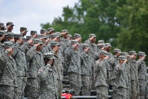 Advance Individual Training students and instructors from the128th Aviation Brigade salute during the Salute to the Nation Ceremony at Seay Plaza on Fort Eustis, Va., July 4, 2015. During the ceremony, members of the Brigade carried a state flag to honor each state in the union. (U.S. Air Force photo by Staff Sgt. Natasha Stannard/Released)