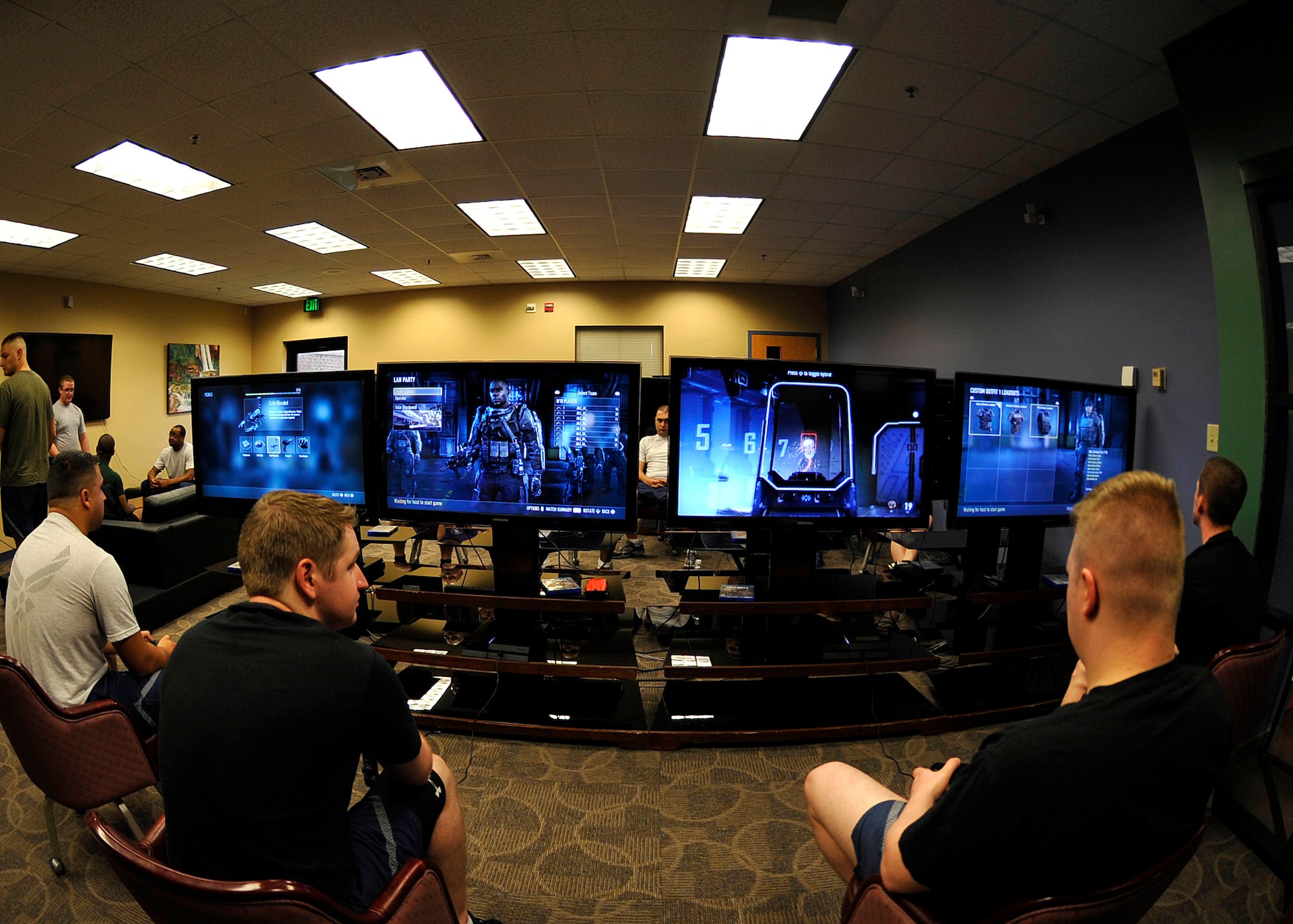 U.S. Air Force Service members engage in a video game tournament during Warrior Day at Langley Air Force Base, Va., July 2, 2015. During the day, Airmen and family members were able to participate in various sports events centered toward raising morale and boosting camaraderie. (U.S. Air Force photo by Senior Airman Breonna Veal/Released)