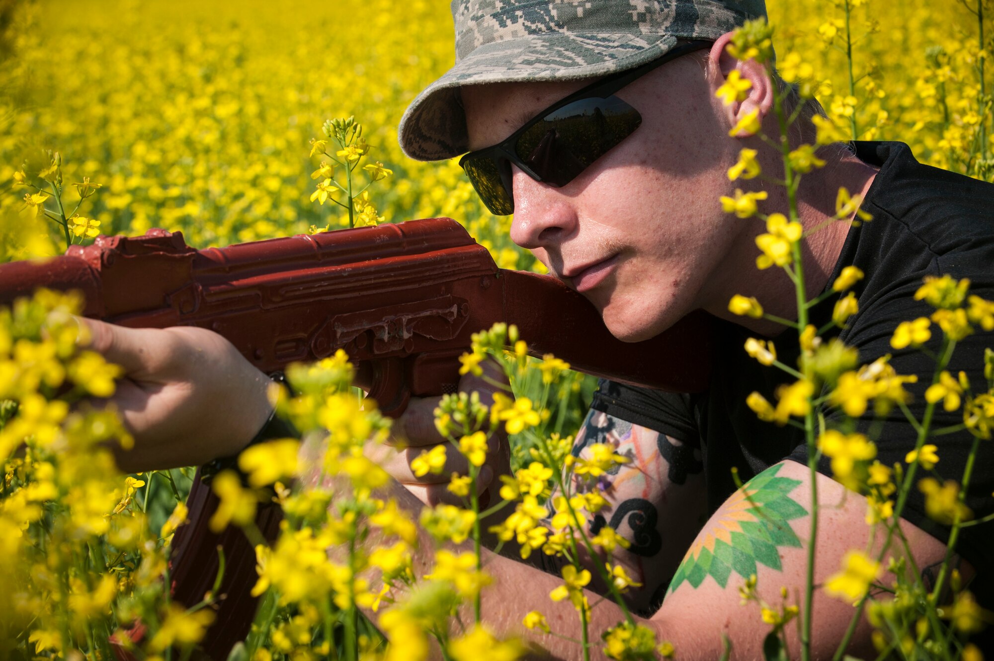 A 91st Missile Wing Security Forces Group member acts as a member of the opposing force during an exercise area near Donnybrook, N.D., June 29, 2015. Members of the opposing force wore civilian clothes and used fake weapons such as M-4 rifles, AK-47 assault rifle and an AT4 anti-tank weapon to fight against security forces members working to recapture a launch facility. (U.S. Air Force photo/Senior Airman Stephanie Morris)