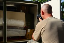 Tech. Sgt. Charles McAllister, 2nd Operations Support Squadron NCO in charge of systems and mobility readiness, takes a photo of a loaded ICU-60 container at Barksdale Air Force Base, La., July 7, 2015. The photographs demonstrate how to load the equipment back into the container for return to the U.S. (U.S. Air Force photo/Senior Airman Benjamin Raughton)
