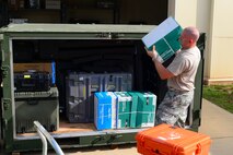Tech. Sgt. Charles McAllister, 2nd Operations Support Squadron NCO in charge of systems and mobility readiness, loads a crate of paper into an ICU-60 container at Barksdale Air Force Base, La., July 7, 2015. The container carries anything Intel Airmen need to perform their job in a deployed location. (U.S. Air Force photo/Senior Airman Benjamin Raughton)