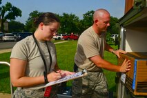 Tech. Sgt. Charles McAllister, 2nd Operations Support Squadron NCO in charge of systems and mobility readiness, right, loads equipment into an ICU-60 container while Senior Airman Emily Boudreaux, 2nd OSS systems and mobility readiness journeyman, logs the equipment at Barksdale Air Force Base, La., July 7, 2015. Systems and mobility readiness section makes sure 2nd OSS Airmen have enough supplies to use on Barksdale or in deployed locations. (U.S. Air Force photo/Senior Airman Benjamin Raughton)