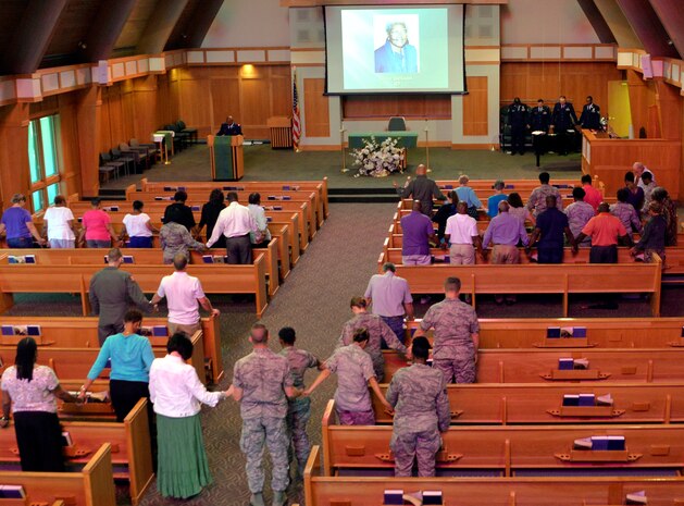 Attendees join hands during the prayer vigil in the chapel on June 25, 2015 at JB Charleston, S.C. The vigil was conducted to support the nine victims of the shooting that occurred at the Emanuel African Methodist Episcopal Church in downtown Charleston, S.C. on June 14th. 