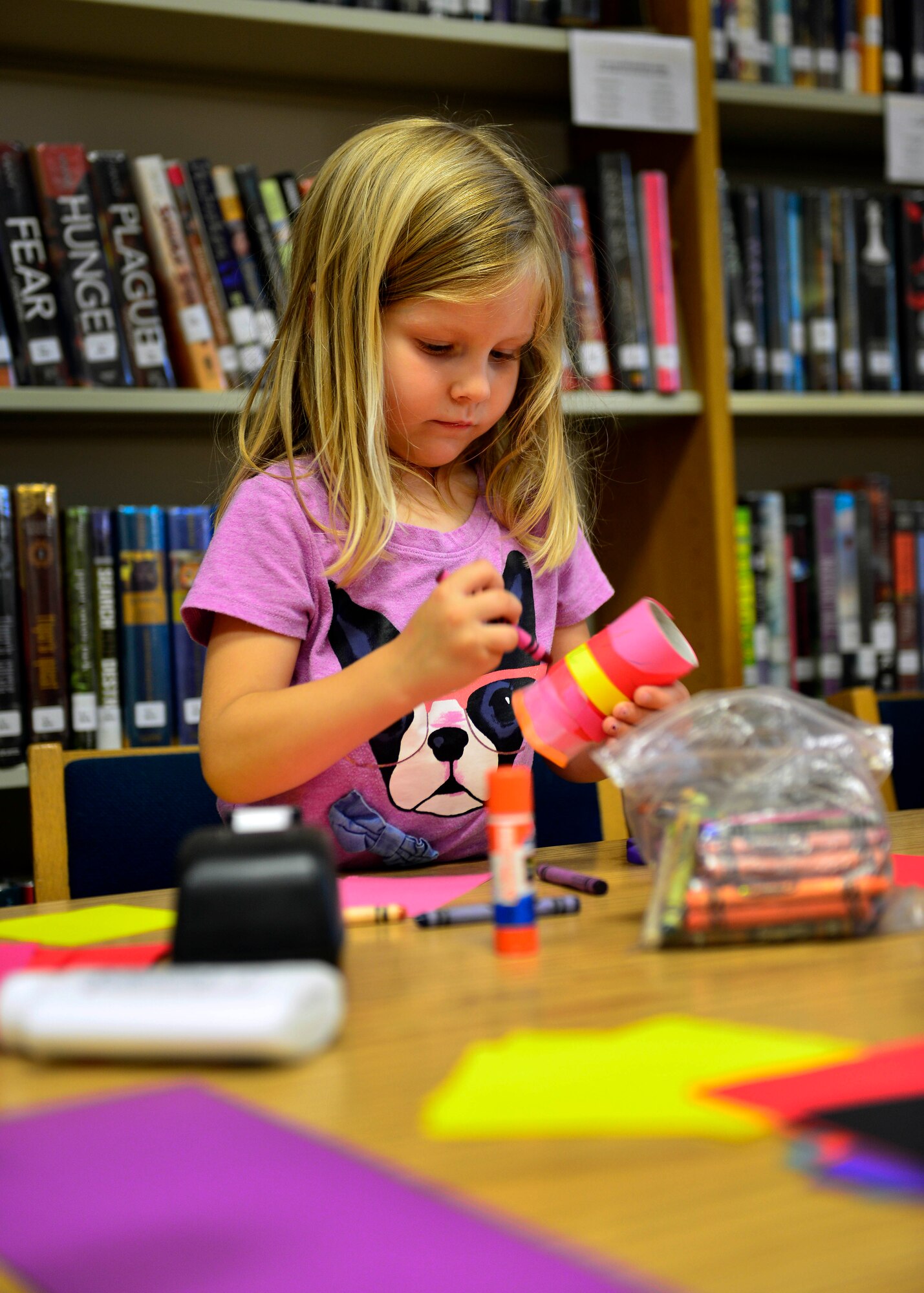 Elise Berensen, daughter of Juliet Berensen, colors a hand-made maraca during story time, July 7, 2015, at Aviano Air Base, Italy. Story time at the library provides children with a learning environment that allows them to interact with other children. (U.S. Air Force photo by Airman 1st Class Cary Smith/Released) 