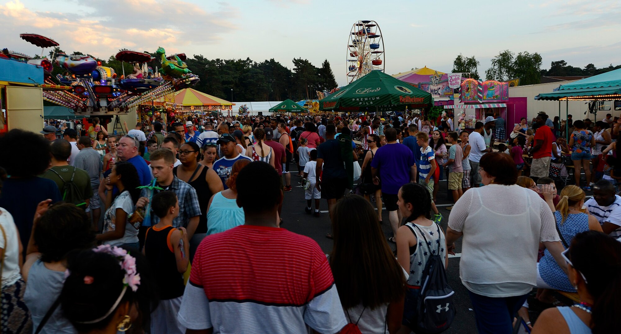 Members of the Kaiserslautern Military Community attend this year’s Freedom Fest July 4, 2015, at Ramstein Air Base, Germany. Despite record heat in Germany, thousands of people attended the two-day event to enjoy rides, games, fireworks and live music. (U.S. Air Force photo/Airman 1st Class Tryphena Mayhugh)
