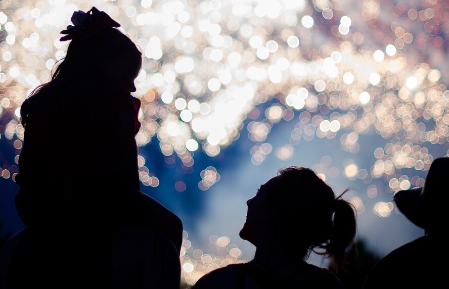 A family watches fireworks during the Freedom Fest, July 4, 2015, at Ramstein Air Base, Germany. The two-day event was held in celebration of the United States’ Independence Day. On the final day attendees were able to enjoy a firework show. (U.S. Air Force photo/Senior Airman Damon Kasberg)