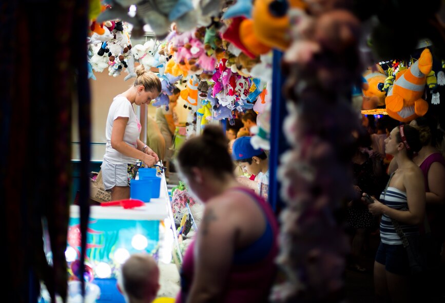 A carnival employee prepares a prize for a winner during this year’s Freedom Fest, July 4, 2015, at Ramstein Air Base, Germany. Both German and American citizens came to the two-day fair to enjoy rides, games, live music and fireworks. (U.S. Air Force photo/Senior Airman Damon Kasberg)