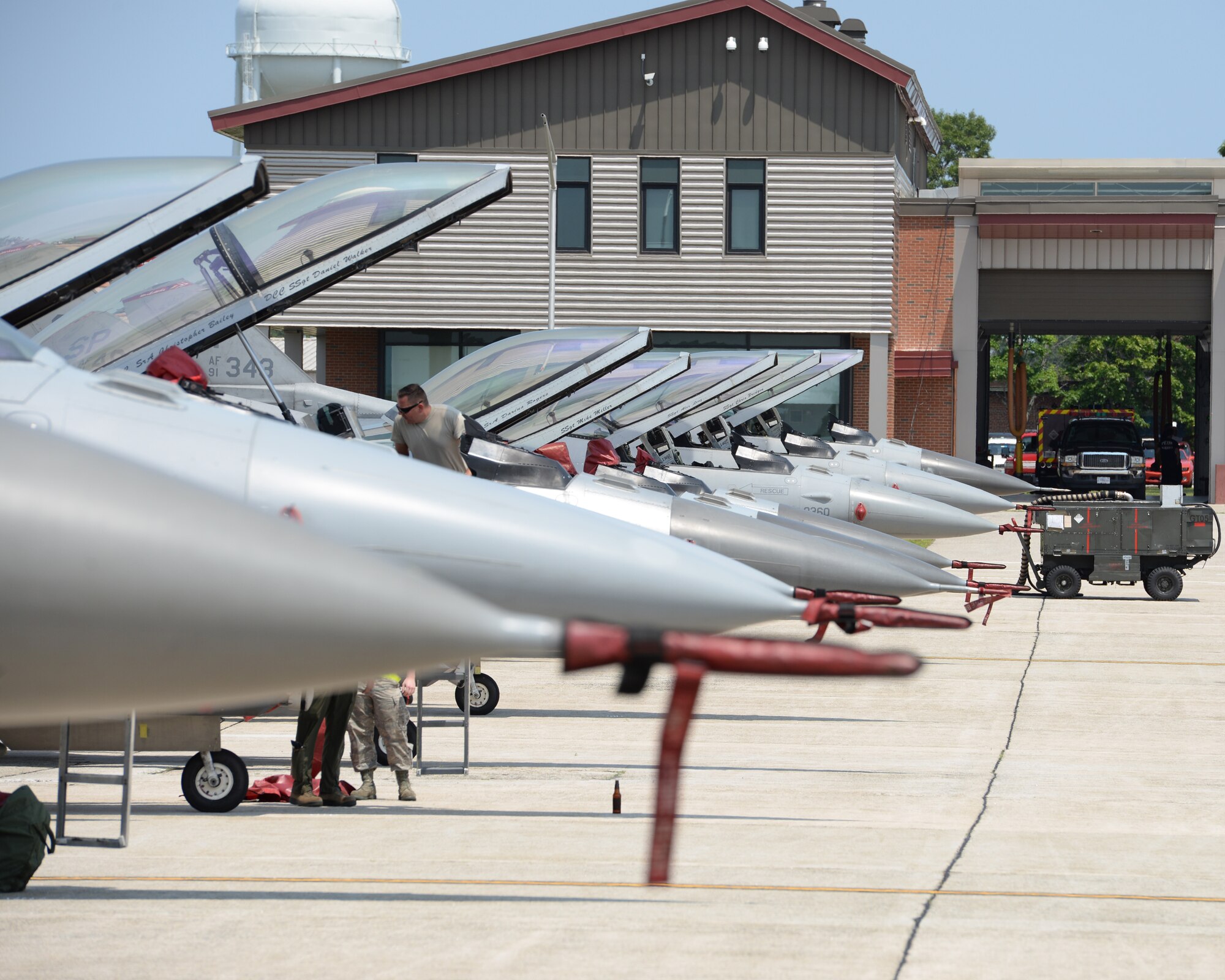 A U.S. Air Force Airman from the 480th Aircraft Maintenance Unit, 52nd Aircraft Maintenance Squadron Spangdahlem Air Base, Germany looks into a cockpit of a F-16C Fighting Falcon at Pease Air National Guard Base, N.H., on July 6, 2015.  A contingent of the Spangdahlem-based aircraft landed at Pease while in transit to a training exercise in the United States. The 52 FW supports the supreme allied commander Europe with mission-ready personnel and systems providing expeditionary air power for suppression of enemy air defenses, close air support, air interdiction, counter air, air strike control, strategic attack, combat search and rescue, and theater airspace control. The wing also supports contingencies and operations other than war as required. (U.S. Air National Guard Base photo by Staff Sgt. Curtis J. Lenz/RELEASED)