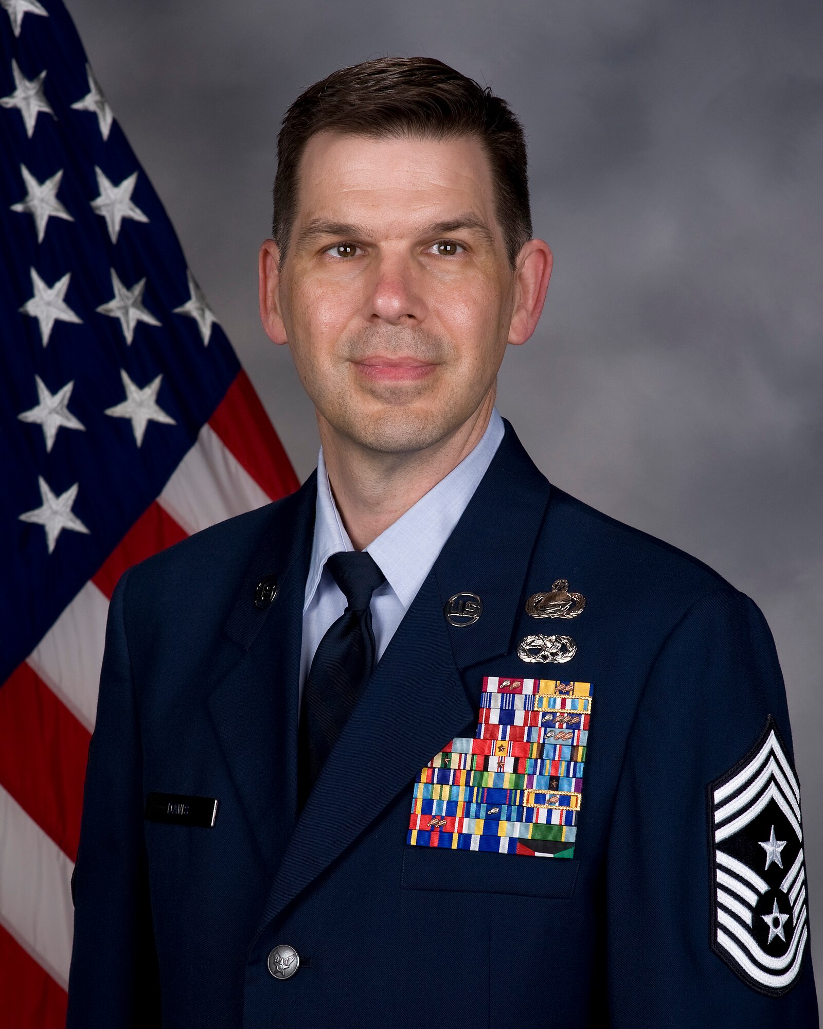 Chief Master Sgt. Keith Davis, 436th Airlift Wing command chief, poses for an official portrait June 1, 2015, at Dover Air Force Base Del. Davis’s responsibilities are to serve as the principle advisor to Col. Michael Grismer, 436th AW commander, on matters of welfare, readiness, morale and the effective employment of the wing’s 3,800 enlisted members. (U.S. Air Force photo/Roland Balik)