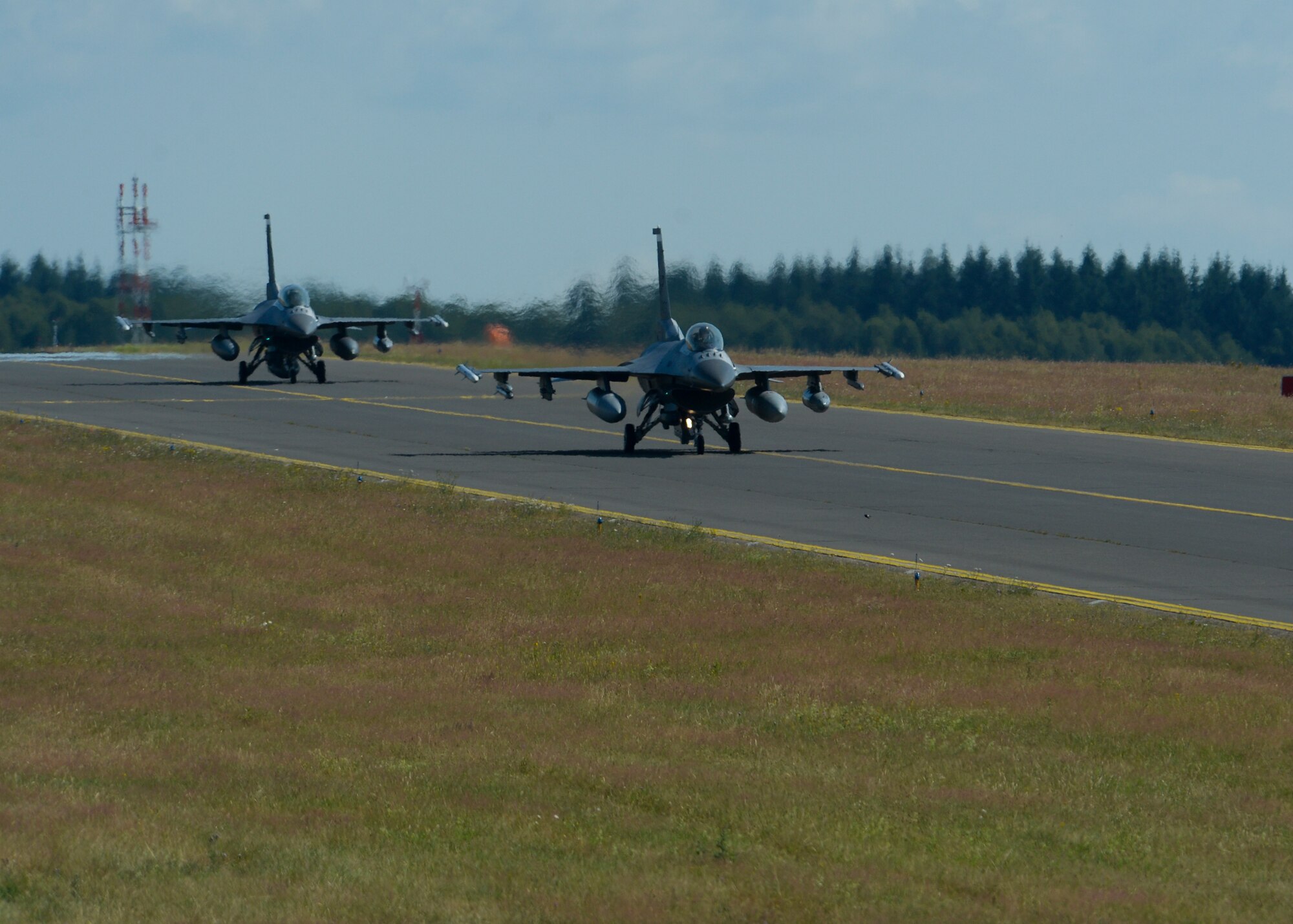 Two U.S. Air Force F-16 Fighting Falcon fighter aircraft assigned to the 480th Fighter Squadron taxi on the flightline at Spangdahlem Air Base, Germany, July 6, 2015. The aircraft will participate in Red Flag, the U.S. Air Force’s premier air-to-air combat training exercise in Nellis Air Force Base, Nevada, July 13-31, 2015. (U.S. Air Force photo by Staff Sgt. Joe W. McFadden/Released)