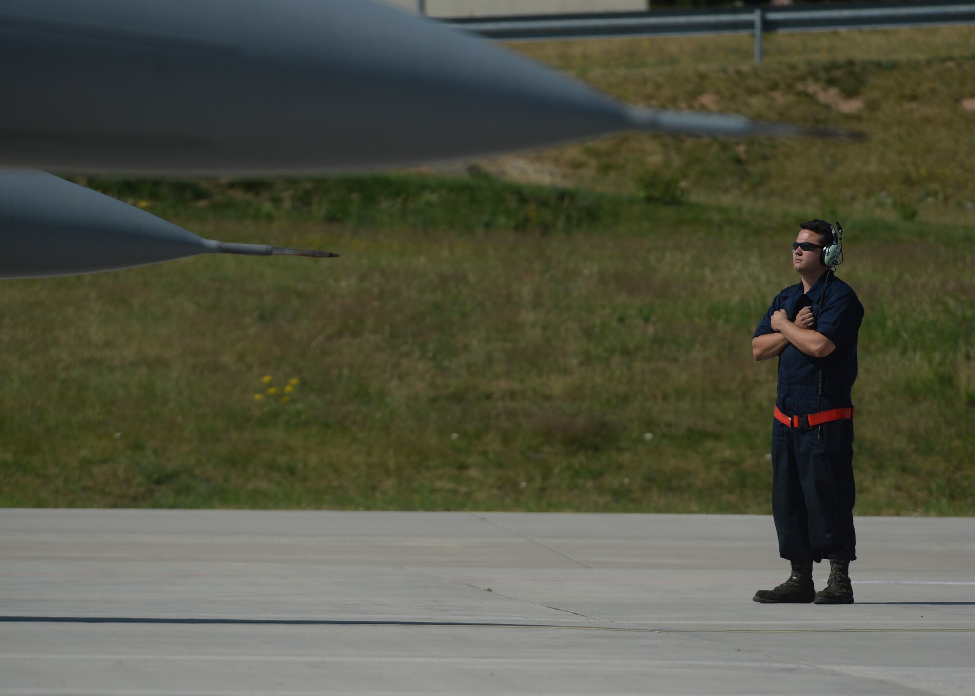 A U.S. Air Force crew chief assigned to the 52nd Aircraft Maintenance Squadron stands by as two F-16 Fighting Falcon fighter aircraft pilots assigned to the 480th Fighter Squadron prepare for taxiing from the flightline at Spangdahlem Air Base, Germany, July 6, 2015. The aircraft will participate in Red Flag, the U.S. Air Force’s premier air-to-air combat training exercise in Nellis Air Force Base, Nevada, July 13-31, 2015. (U.S. Air Force photo by Staff Sgt. Joe W. McFadden/Released)
