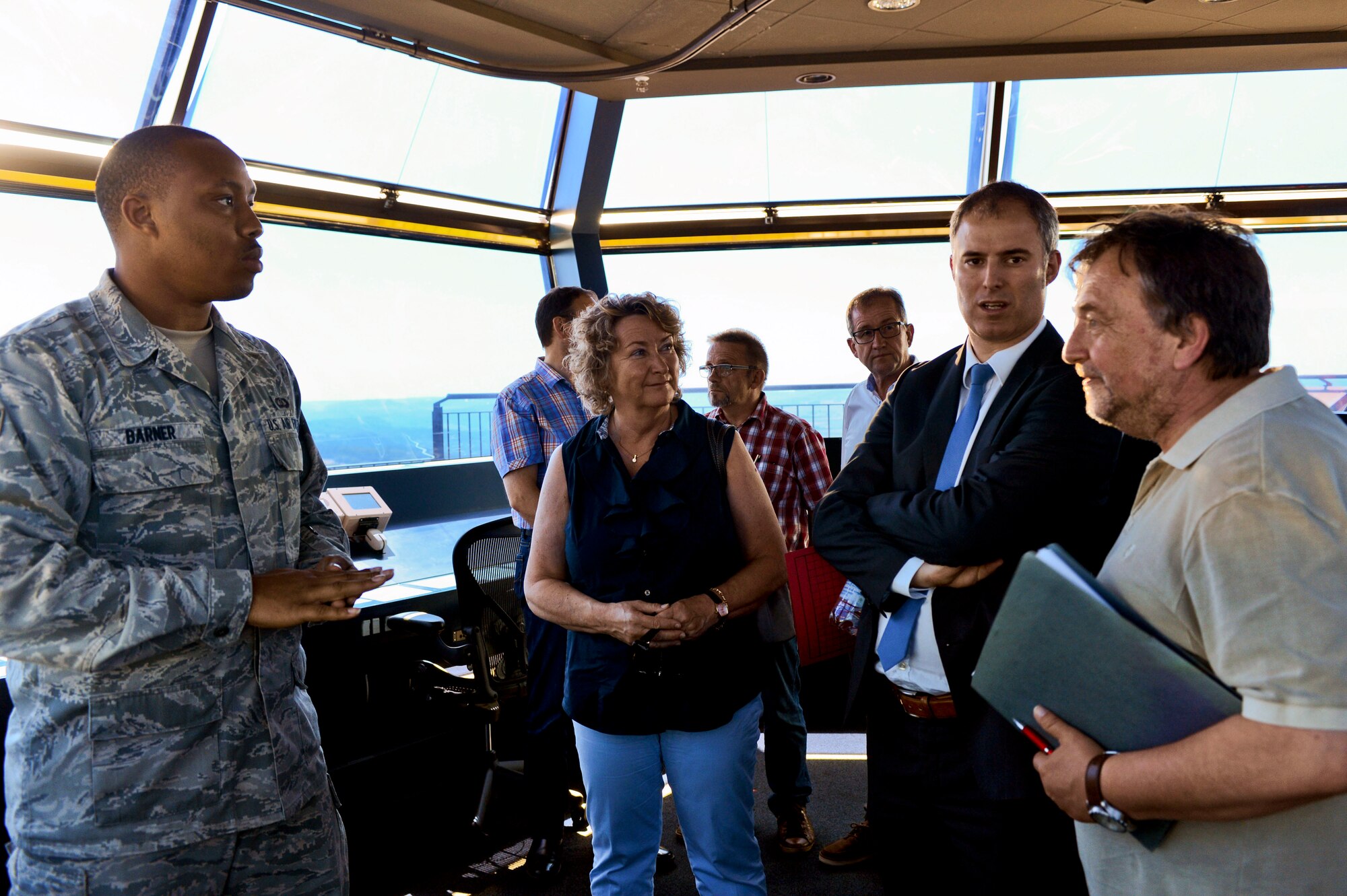 Local German leaders receive a briefing from a 52nd Operations Support Squadron air traffic controller briefs on air traffic control operations during a base orientation tour at Spangdahlem Air Base, Germany, July 1, 2015. The control tower helps coordinate flying operations for the base. (U.S. Air Force photo by 2nd Lt Meredith Mulvihill/Released)