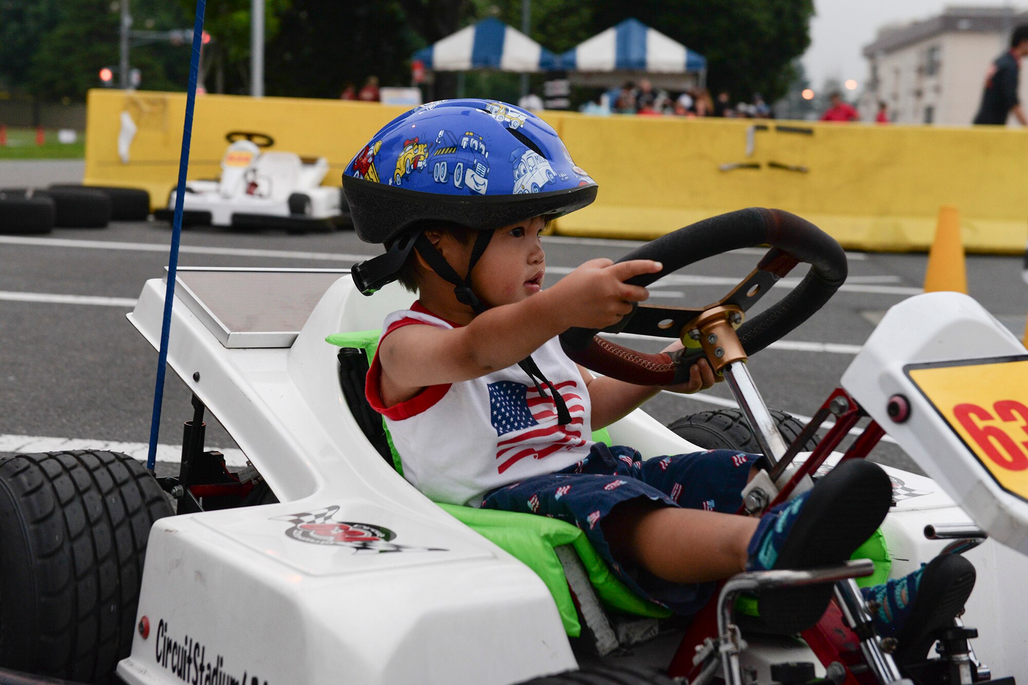 A child drives a go-kart around a track during the Celebrate America festival at Yokota Air Base, Japan, July 2, 2015. Celebrate America provided Yokota personnel and their families the opportunity to relax and strengthen camaraderie while remembering America’s independence. (U.S. Air Force photo by Airman 1st Class Elizabeth Baker/Released)
