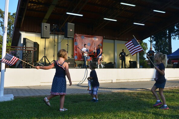 Children dance as American singer Alaina Blair, Armed Forces Entertainment performer, sings a song from her new album Anthem during ta 4th of July Festival July 4, 2015, at Incirlik Air Base, Turkey. As part of her tour with AFE, Blair has performed in Djibouti, Kuwait, Bahrain, Qatar, UAE, Turkey, Jordan, and Egypt. (U.S. Air Force photo by Senior Airman Michael Battles/Released)