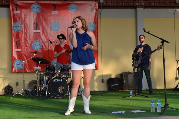 Alaina Blair, American singer and Armed Forces Entertainment performer, sings the National Anthem during a 4th of July Festival July 4, 2015, at Incirlik Air Base, Turkey. Blair was a contestant on season seven of “The Voice.” (U.S. Air Force photo by Senior Airman Michael Battles/Released)