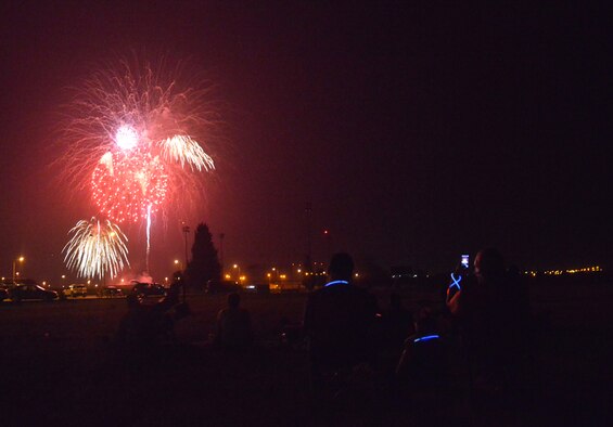 Members of Team Incirlik watch a firework display during a 4th of July Festival July 4, 2015, at Incirlik Air Base, Turkey. Along with fireworks, attendees of the festival received a performance from special guest Alaina Blair, American singer and Armed Forces Entertainment performer. (U.S. Air Force photo by Senior Airman Michael Battles/Released)