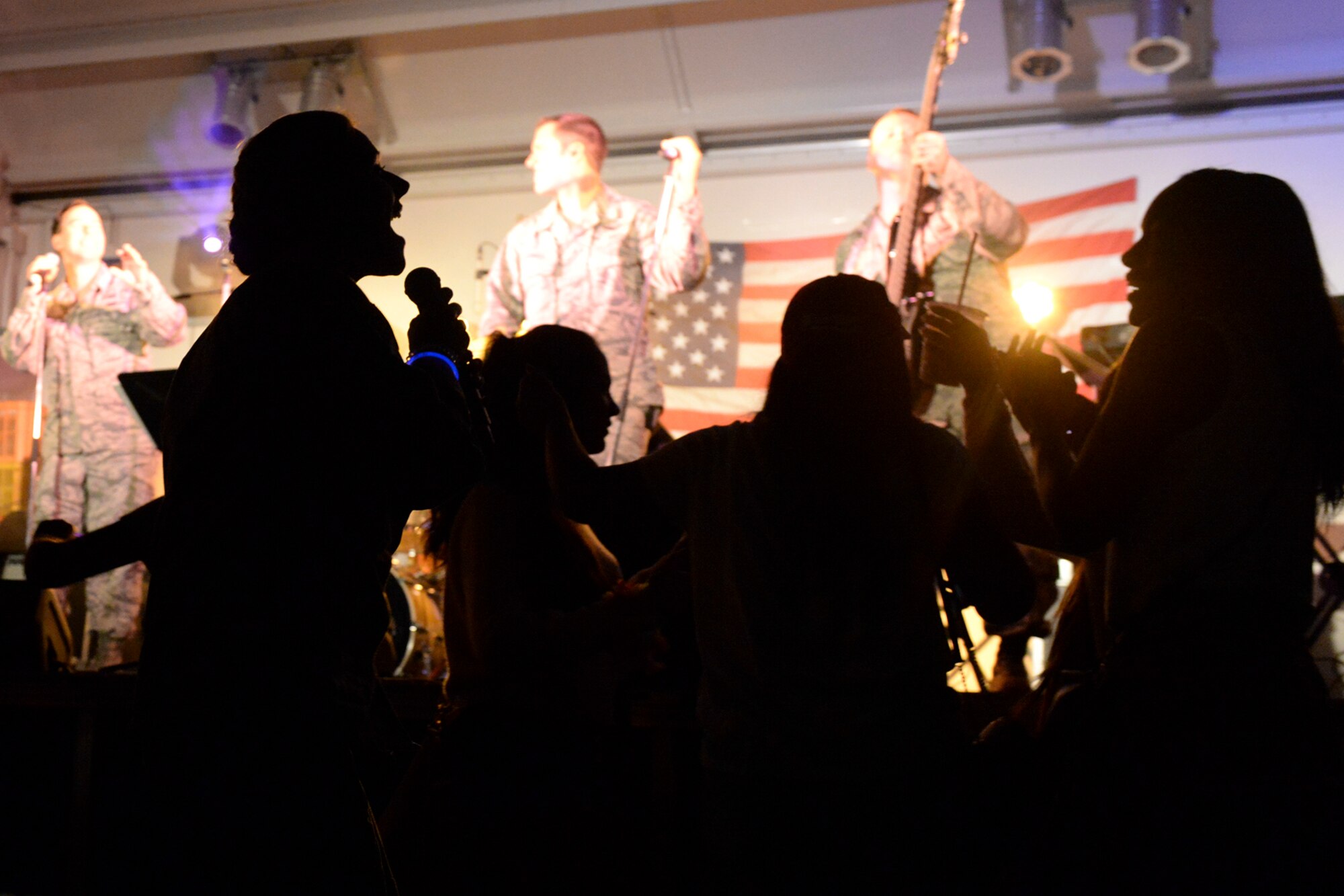 A Band of the Pacific-Hawaii performer sings for the audience at Yokota Air Base, Japan, July 2, 2015. The band performed popular songs with themes celebrating America and in honor of Independence Day. (U.S. Air Force photo by Airman 1st Class Elizabeth Baker/Released)