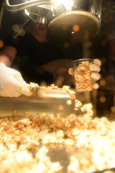 Fresh caramel popcorn is served at one of the concession stands during the Celebrate America festival at Yokota Air Base, Japan, July 2, 2015. Food stands supported the Celebrate America festivities with a variety of classic American snacks such as popcorn and cotton candy. (U.S. Air Force photo by Airman 1st Class Elizabeth Baker/Released)