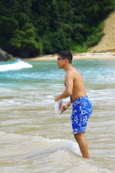 Staff Sgt. Deaven Randolph prepares to toss a Frisbee, June 27, 2015, at Tadato Beach in Shimoda, Japan. In addition from surf lessons, the retreat utilized group discussion to help deepen participants' spirituality. (U.S. Air Force photo by Airman 1st Class Delano Scott/Released)