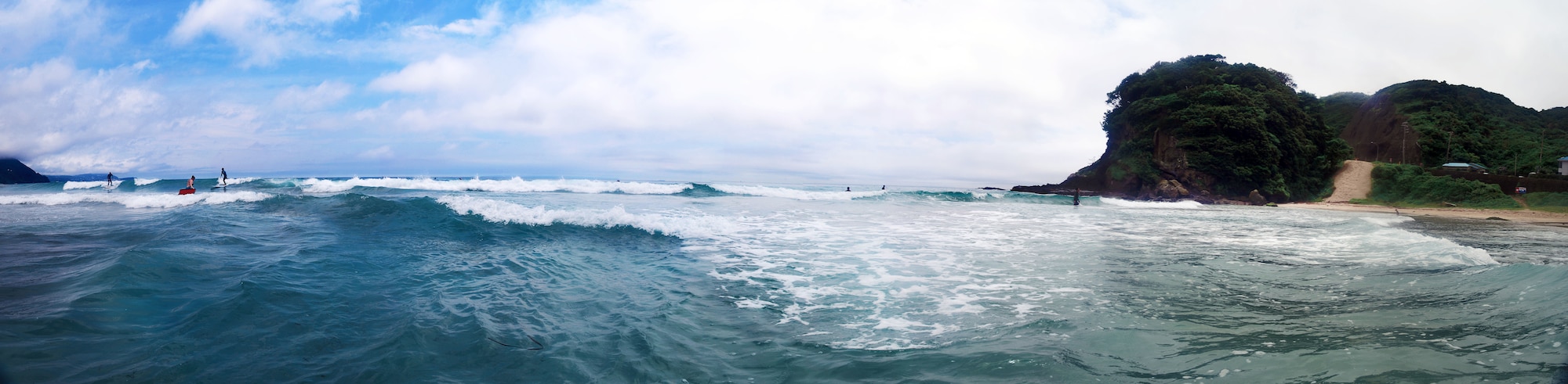 Airmen from Yokota Air Base and Japanese locals surf the waves of Tadato Beach in Shimoda, Japan, June 27, 2015. The surf retreat prepared enabled Airmen to strengthen their relationship skills and spirituality. (U.S. Air Force graphic by Airman 1st Class Delano Scott/Released)