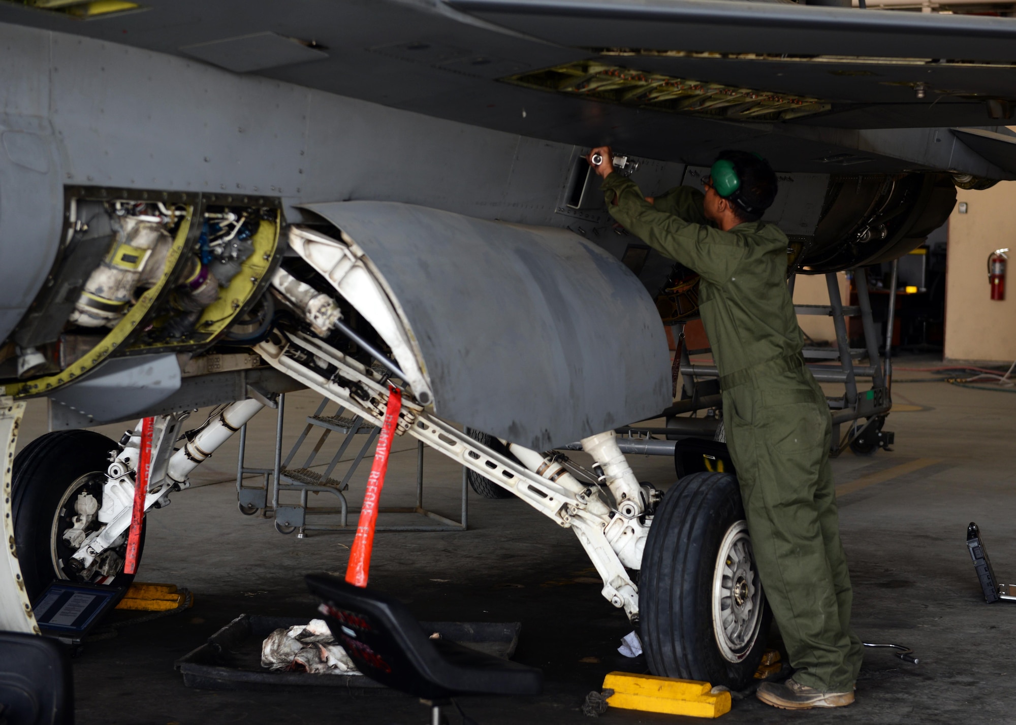 U.S. Air Force Senior Airman Omar Segusulaiman, 455th Expeditionary Aircraft Maintenance Squadron F-16 aircraft maintainer, works on a jet during a routine phase inspection July 7, 2015, at Bagram Airfield, Afghanistan. The team, who has been deployed to BAF for two months, is working on their 12th phase inspection that occurs after a jet has reached 400 flying hours. (U.S. Air Force photo by Senior Airman Cierra Presentado/Released) 