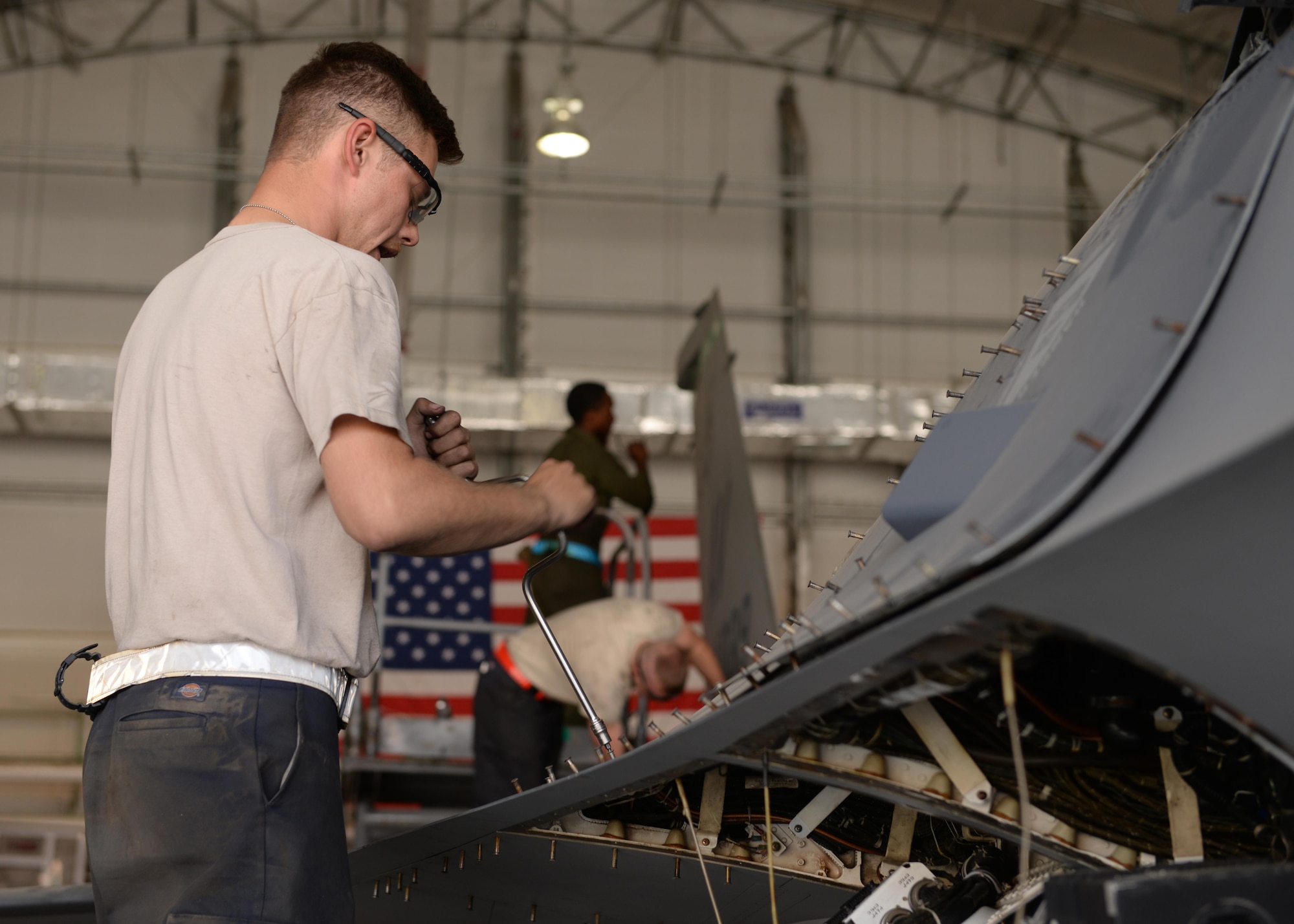 U.S. Air Force Senior Airman Nicolas Smith, 455th Expeditionary Aircraft Maintenance Squadron F-16 aircraft maintainer, works on a jet during a phase inspection July 7, 2015, at Bagram Airfield, Afghanistan. The phase inspection team, who has been deployed to BAF for two months, is working on their 12th phase inspection that occurs after a jet has reached 400 flying hours. (U.S. Air Force photo by Senior Airman Cierra Presentado/Released)