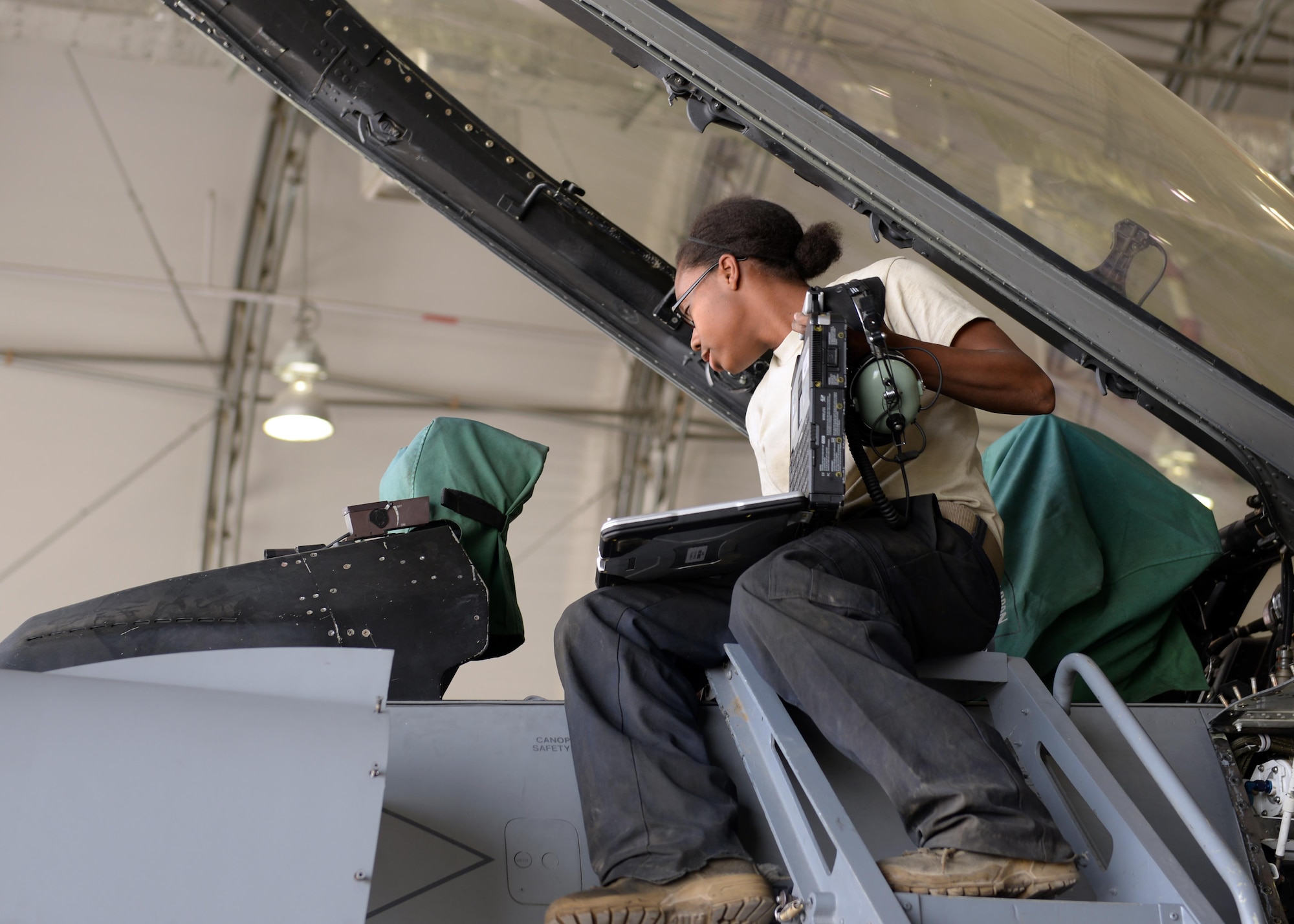 U.S. Air Force Senior Airman Kristina Manning, 455th Expeditionary Aircraft Squadron F-16 maintainer, inspects the inside of the cockpit during a phase inspection July 7, 2015, at Bagram Airfield, Afghanistan. The phase inspection team, who has been deployed to BAF for two months, is working on their 12th phase inspection that occurs after a jet has reached 400 flying hours. (U.S. Air Force photo by Senior Airman Cierra Presentado/Released)