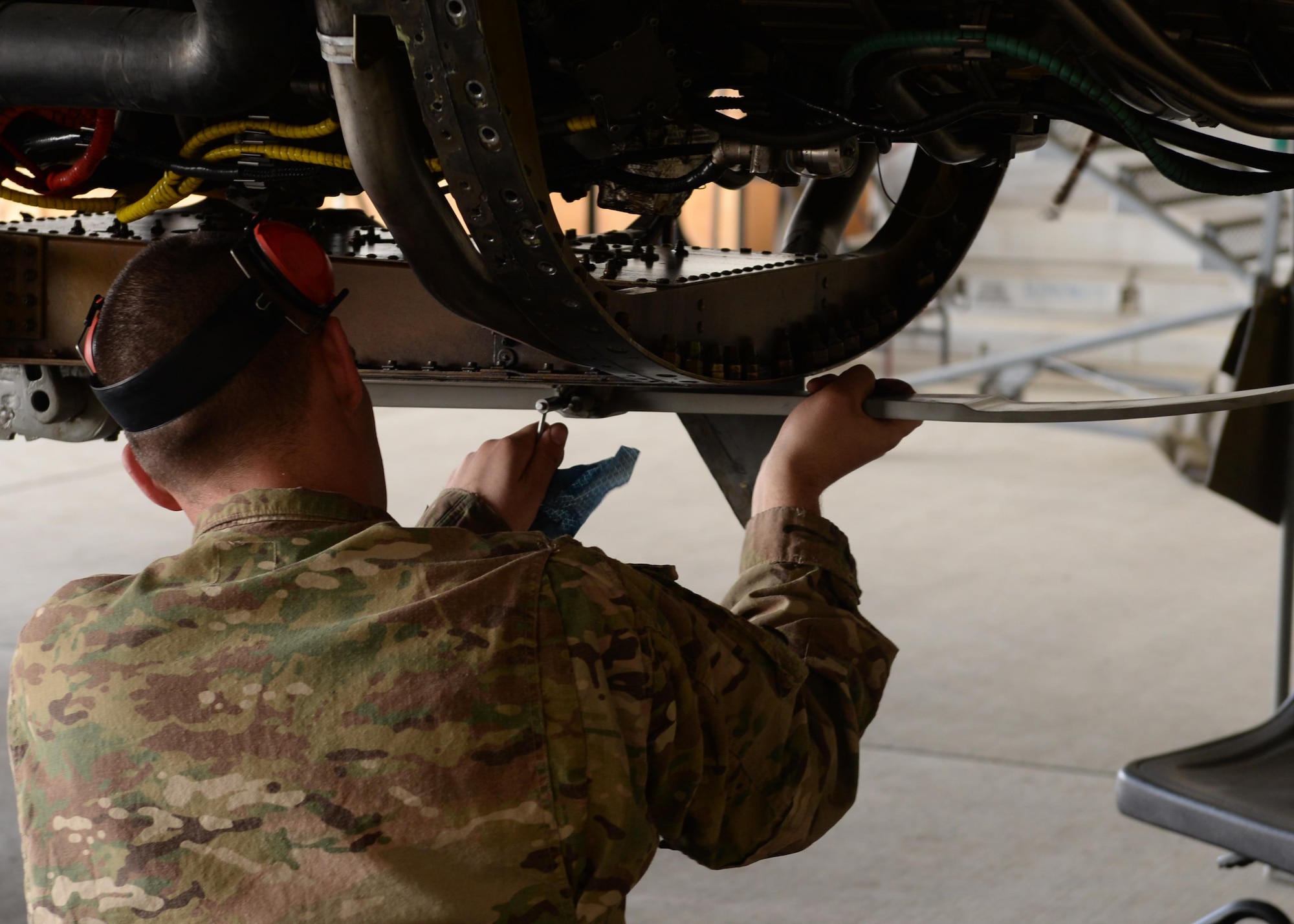 U.S. Air Force TSgt. Charles Nichols, 455th Expeditionary Aircraft Maintenance Squadron F-16 aircraft maintainer, works on a jet during a routine phase inspection July 7, 2015, at Bagram Airfield, Afghanistan. The phase inspection team, who has been deployed to BAF for two months, is working on their 12th phase inspection that occurs after a jet has reached 400 flying hours. (U.S. Air Force photo by Senior Airman Cierra Presentado/Released)