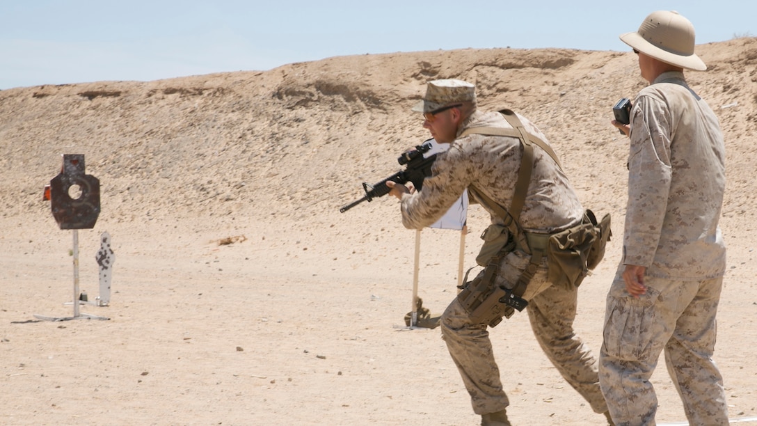 Cpl. Eric Rueseler, marksmanship trainer, Weapons and Training Battalion, Camp Pendleton, practices firing on the move during the Western Regional Combat Match at the Combat Center Rifle Range, June 30, 2015. The match consisted of two days of practice and two days of recorded matches. (Official Marine Corps photo by Lance Cpl. Thomas Mudd/ Released)