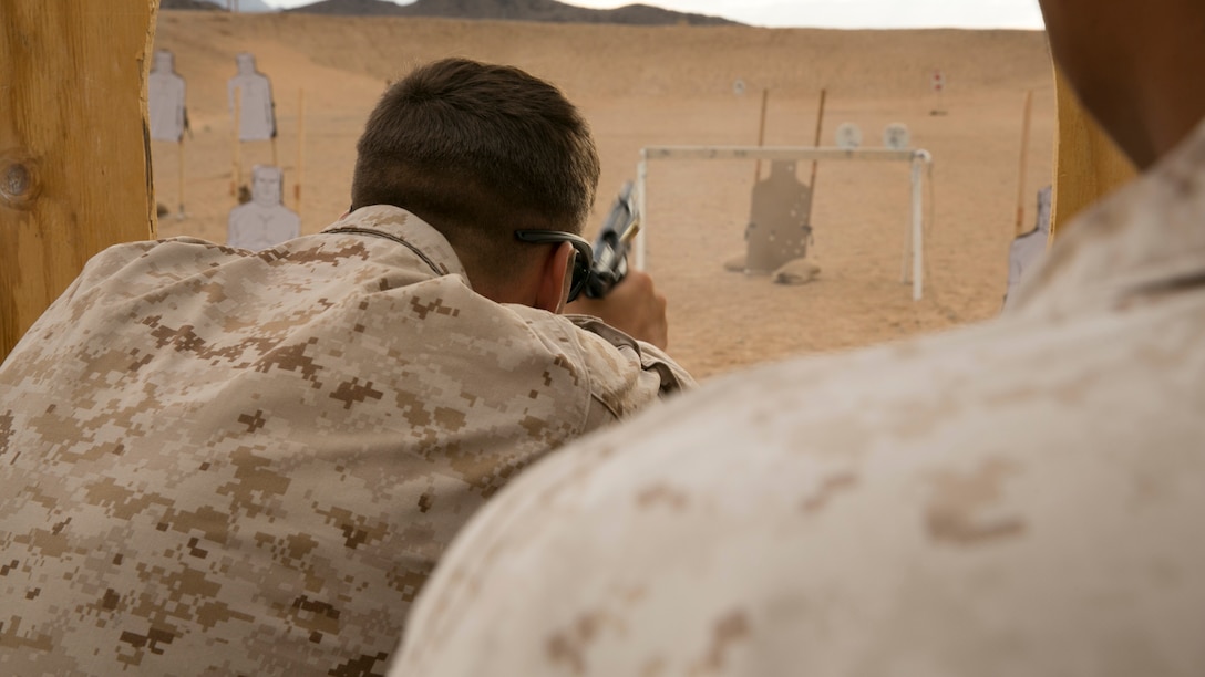 Lance Cpl. Brandon Reasoner, semi-refueler operator, Marine Wing Support Squadron 372, Camp Pendleton, practices with the M9 pistol during the Western Regional Combat Match at the Combat Center Rifle Range, June 30, 2015. Each course of fire was unique and changed each day to continuously challenge the participating Marines. (Official Marine Corps photo by Lance Cpl. Thomas Mudd/ Released)