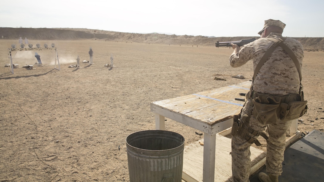 Cpl. Eric Rueseler, marksmanship trainer, Weapons and Training Battalion, Camp Pendleton, fires a Benelli M1014 shotgun during the Western Regional Combat Match at the Combat Center Rifle Range, July 2, 2015. The courses of fire gave the Marines the opportunity to use multiple skills during the match. (Official Marine Corps photo by Lance Cpl. Thomas Mudd/ Released)