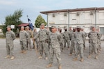 North Carolina National Guard members, assigned to 1st Combined Arms Battalion, 252nd Armor Regiment, out of Fayetteville, stand in formation during a transition of authority ceremony at Camp Marechal de Lattre de Tassigny, Kosovo, July 4, 2015.