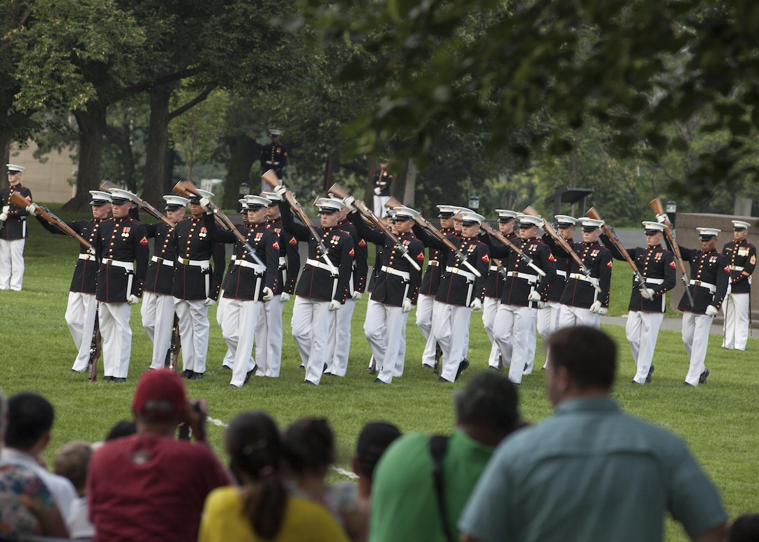 The Silent Drill Platoon, Marine Barracks Washington, D.C. performs during the Sunset Parade at the Marine Corps War Memorial in Arlington, Va., July 7, 2015. Medal of Honor recipient Hershel Woodrow "Woody" Williams was the guest of honor for the Sunset Parade and the deputy commandant of plans, policies and operations, Lt. Gen. Ronald L. Bailey was the hosting official for that same parade. Williams is the last surviving Medal of Honor recipient from the battle of Iwo Jima, World War II. (U.S. Marine Corps photo by Lance Cpl. Christopher J. Nunn/Released)